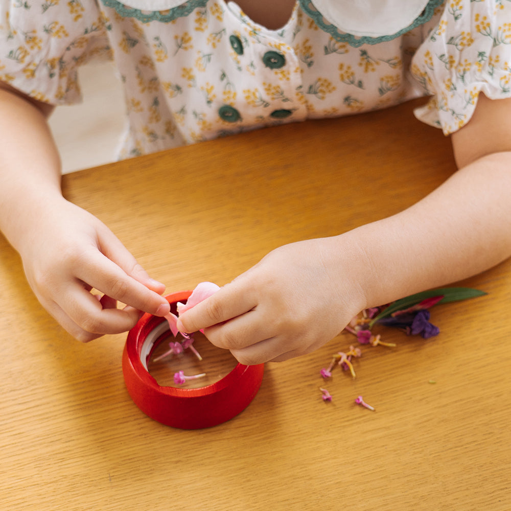 Kid Using Flowers Inside Kaleidoscope