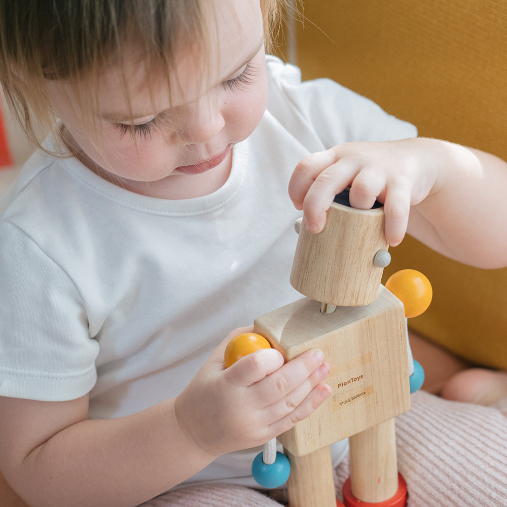 Toddler Adding a New Emotion Face to Build-a-Robot