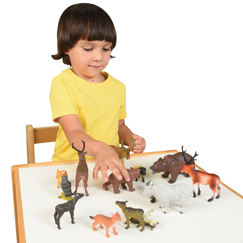 Child Engaging with Forest Animals Figures