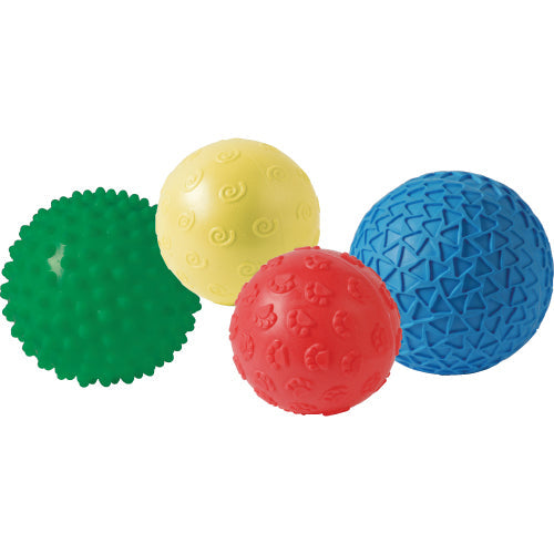 A set of four colorful textured balls, each a different color: green, yellow, red, and blue. The balls have various textures designed for tactile play.