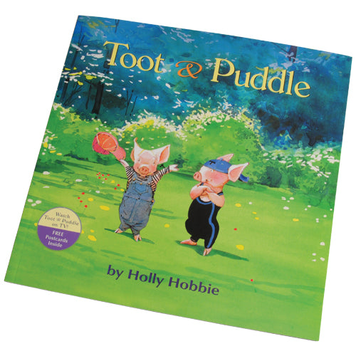 A children's book titled 'Toot & Puddle' with an illustration of two cartoon pigs playing with a ball in a field.