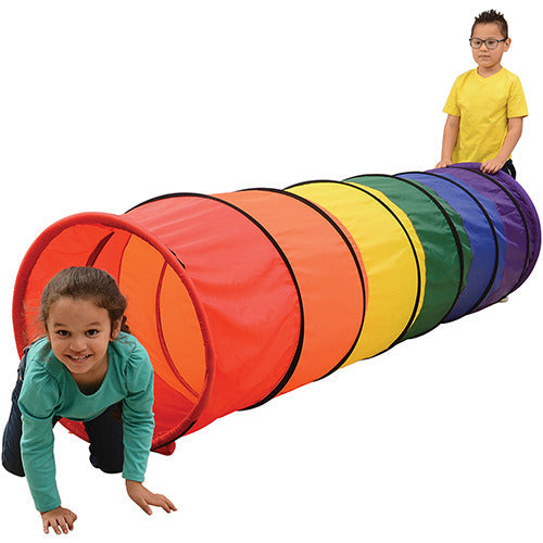 Two children playing with colorful crawling tunnel on white background