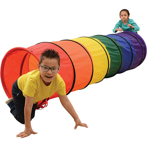 Two children playing with colorful crawling tunnel on white background