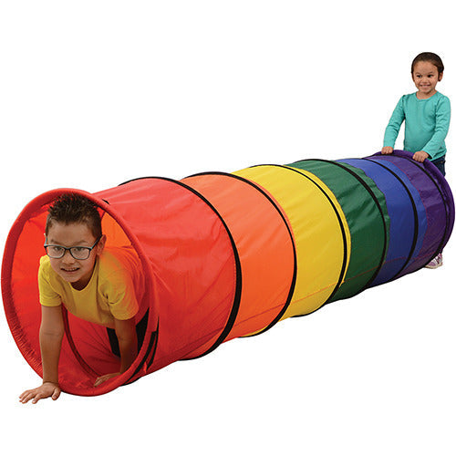 Two children playing with colorful crawling tunnel on white background