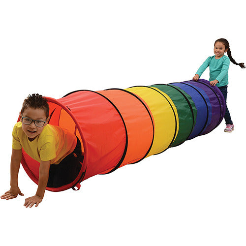Two children playing with colorful crawling tunnel on white background