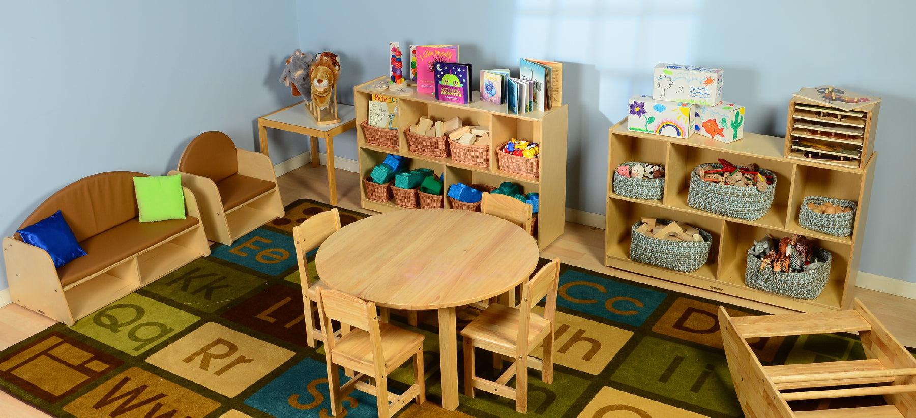 pre-k classroom with tables, couch, chairs and shelving