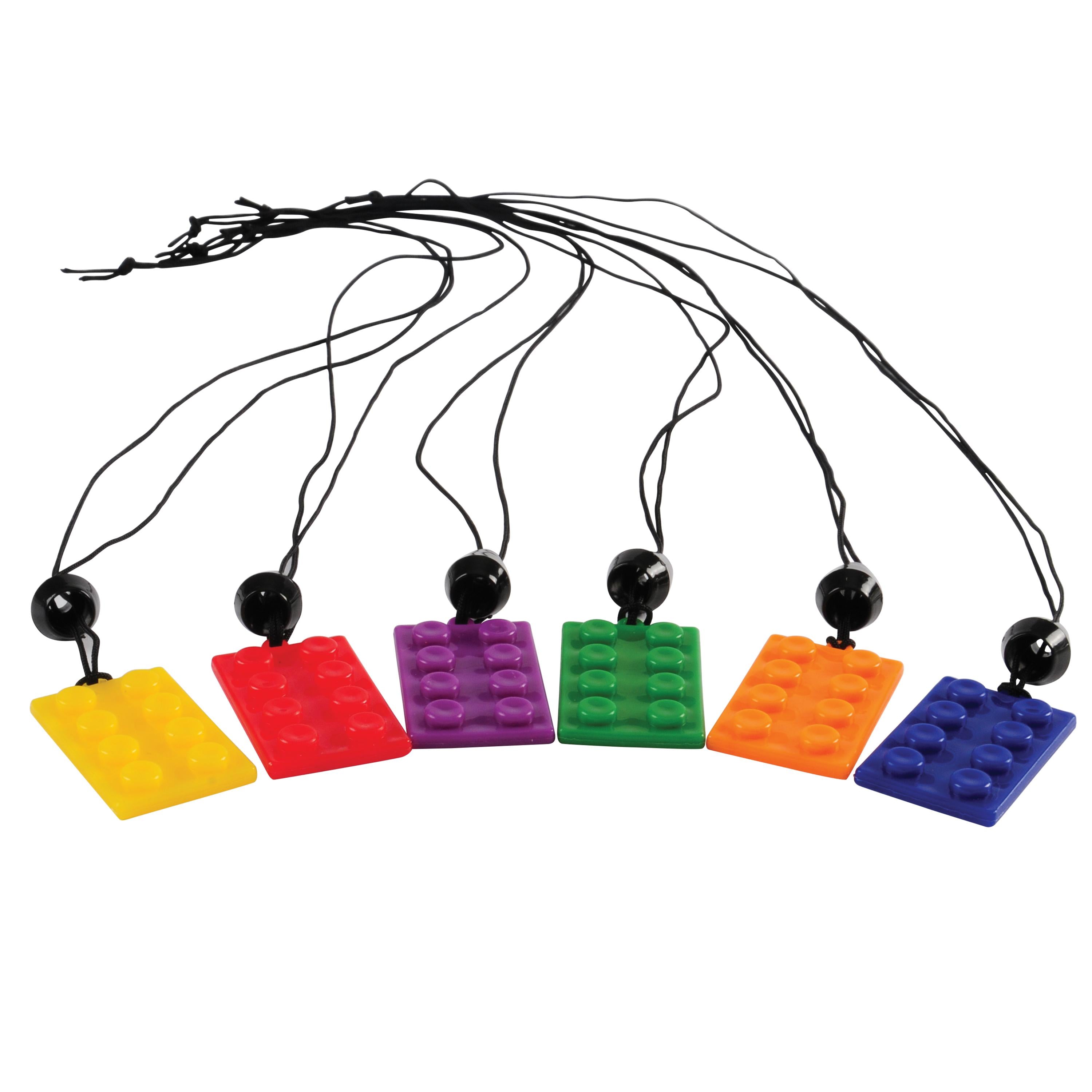 Colorful building block pendants on black strings against a white background