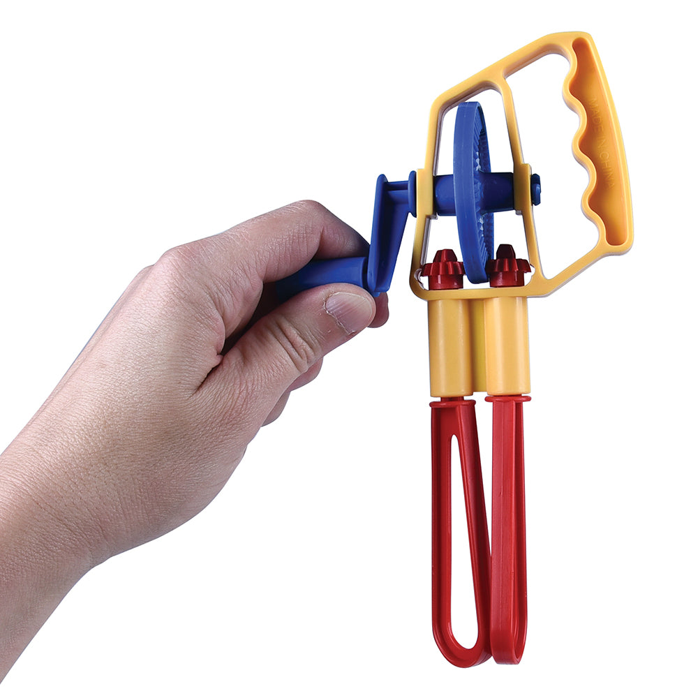 Colorful toy kitchen utensil held by a hand on a white background