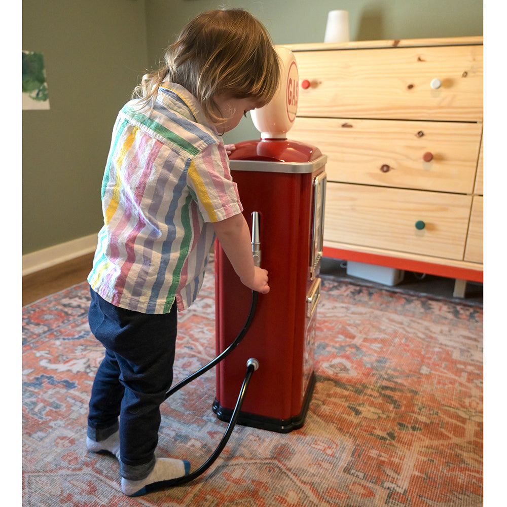 Toddler Playing with the Hose on Steel Gas Pump Replica