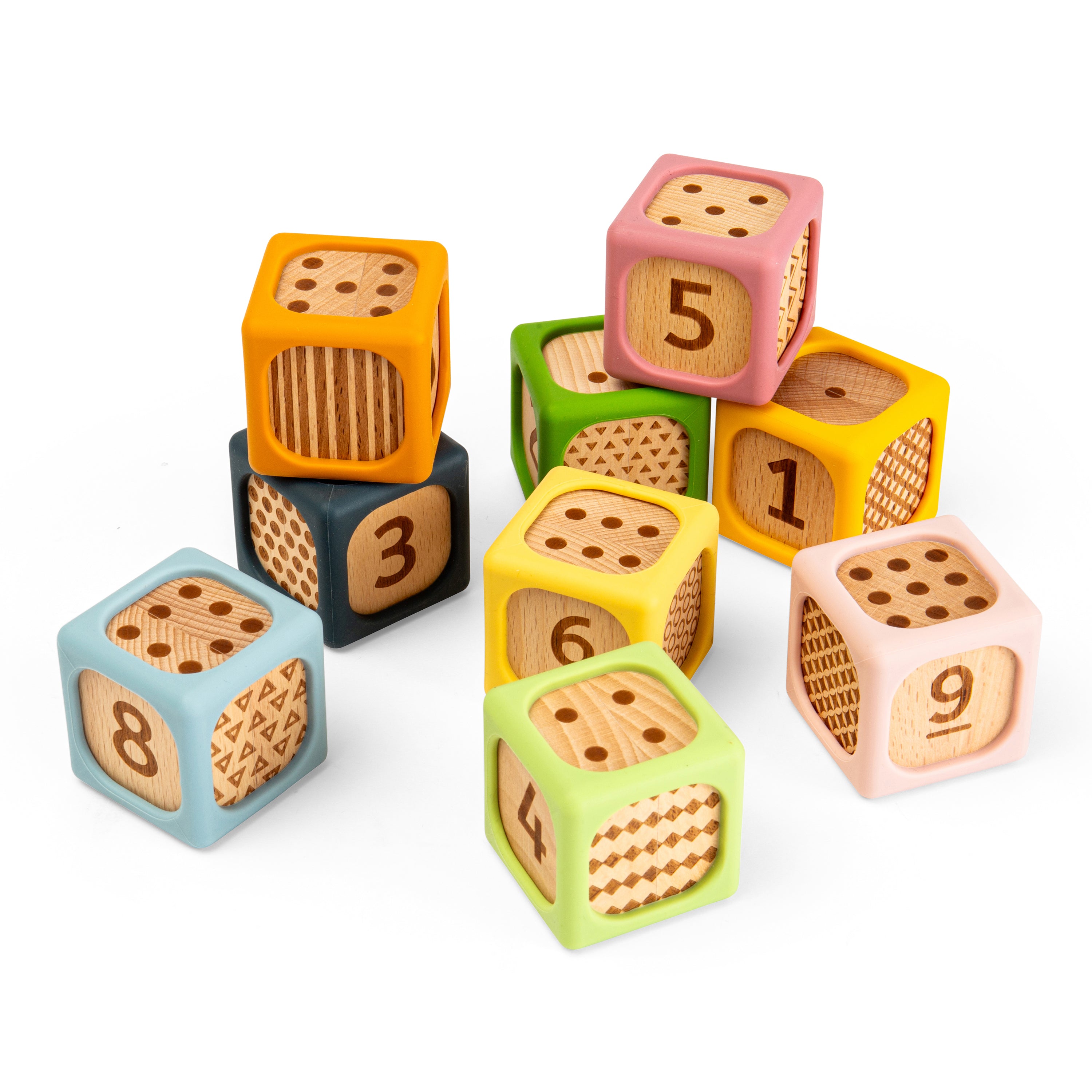 A set of colorful wooden number cubes arranged on a plain white background. The cubes are painted in pastel and bright colors including pink, yellow, green, blue, orange, and dark gray, with natural wood showing on the faces that display numbers from 1 to 9.