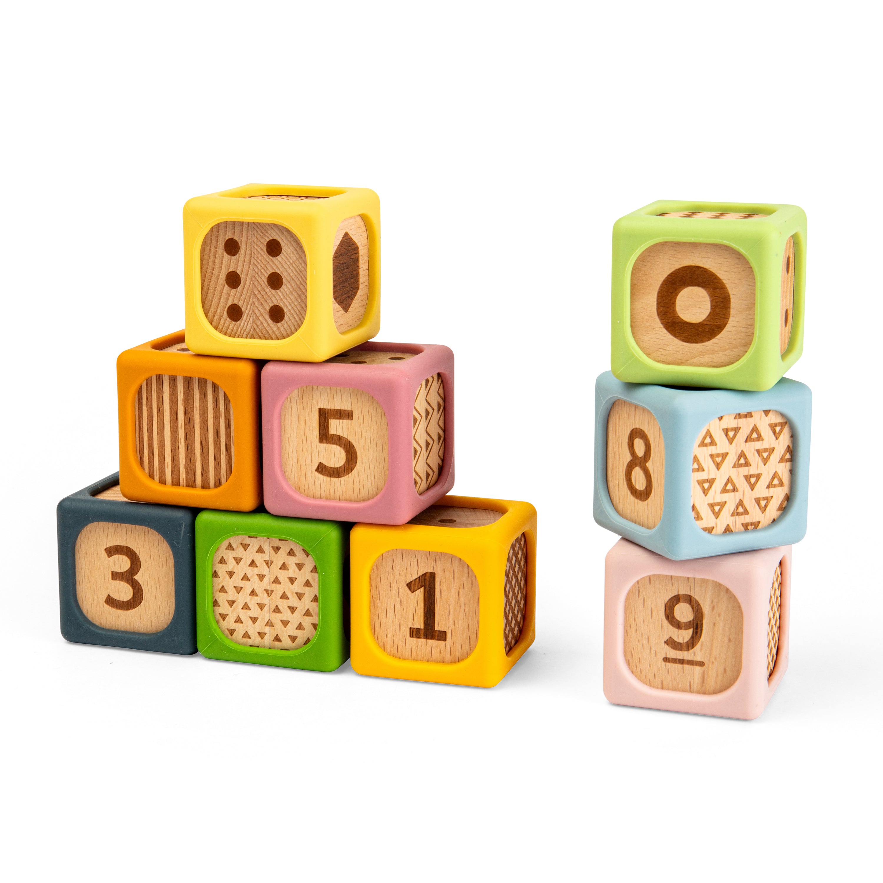 Colorful wooden number and pattern blocks arranged in two stacks on a white background.