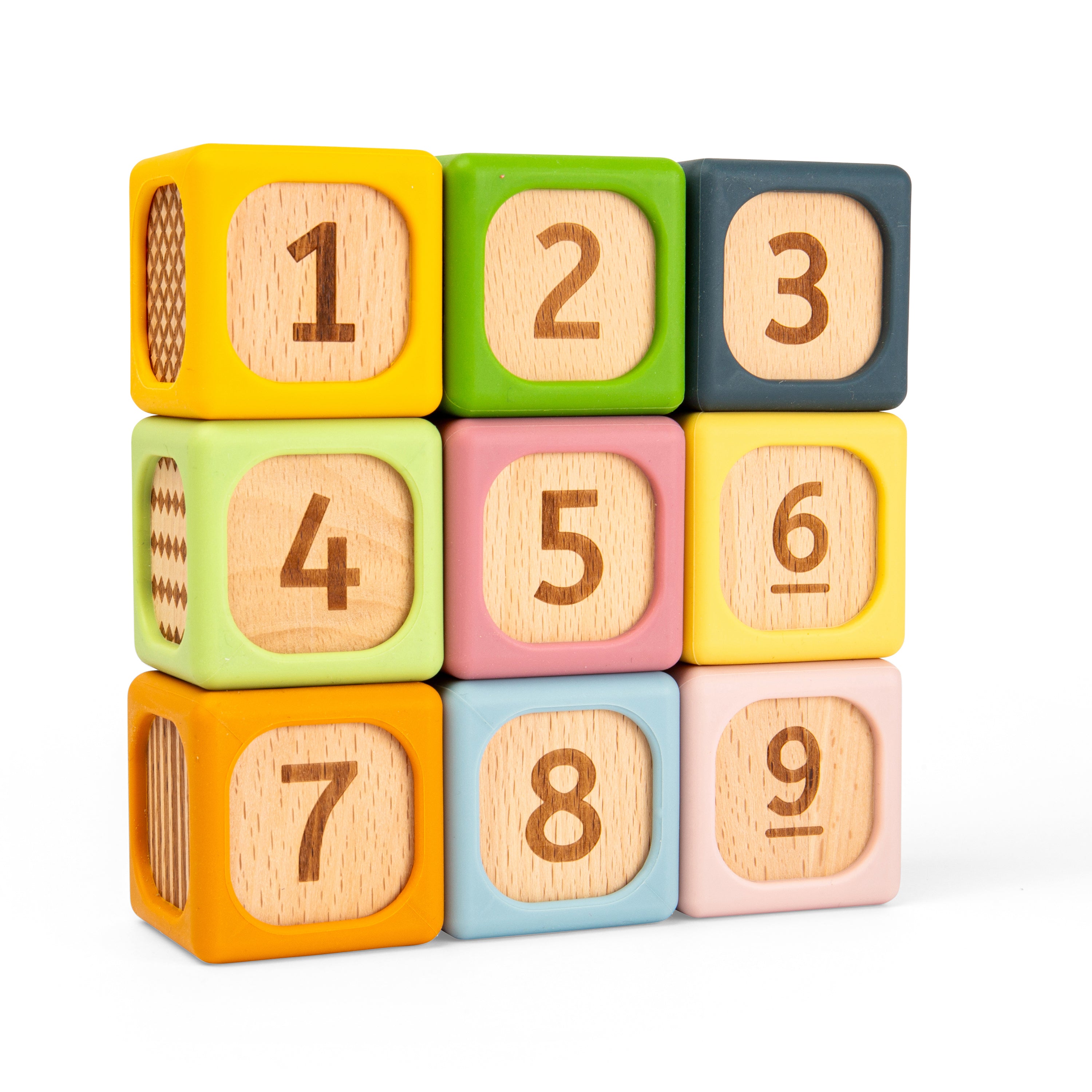 A set of colorful wooden number blocks arranged in a 3-by-3 grid on a white background. The blocks are yellow, green, blue-gray, light green, pink, yellow, orange, light blue, and pale pink, each with a natural wood insert showing a number from 1 to 9.