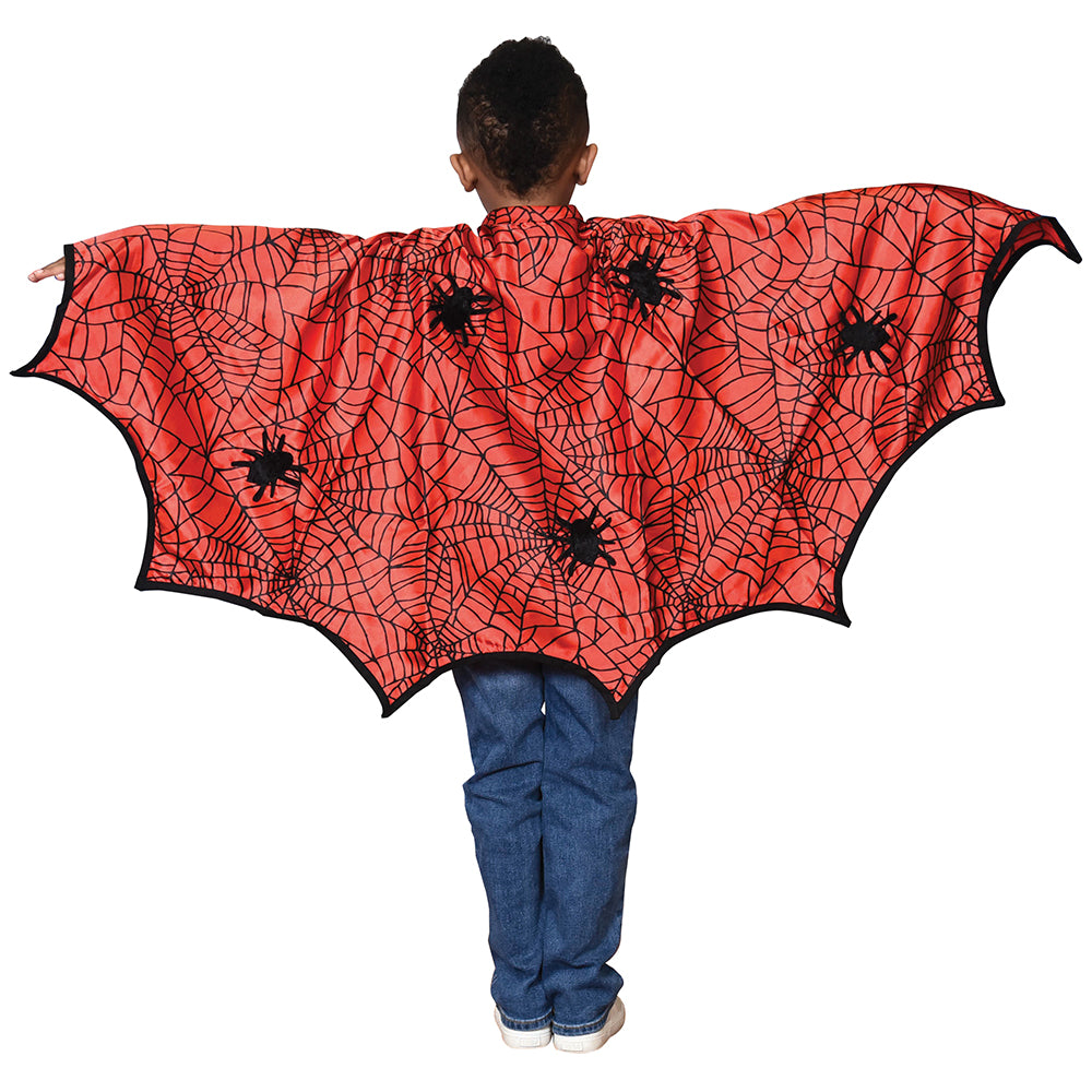 Kid Modeling Red Cape With Black Spiders