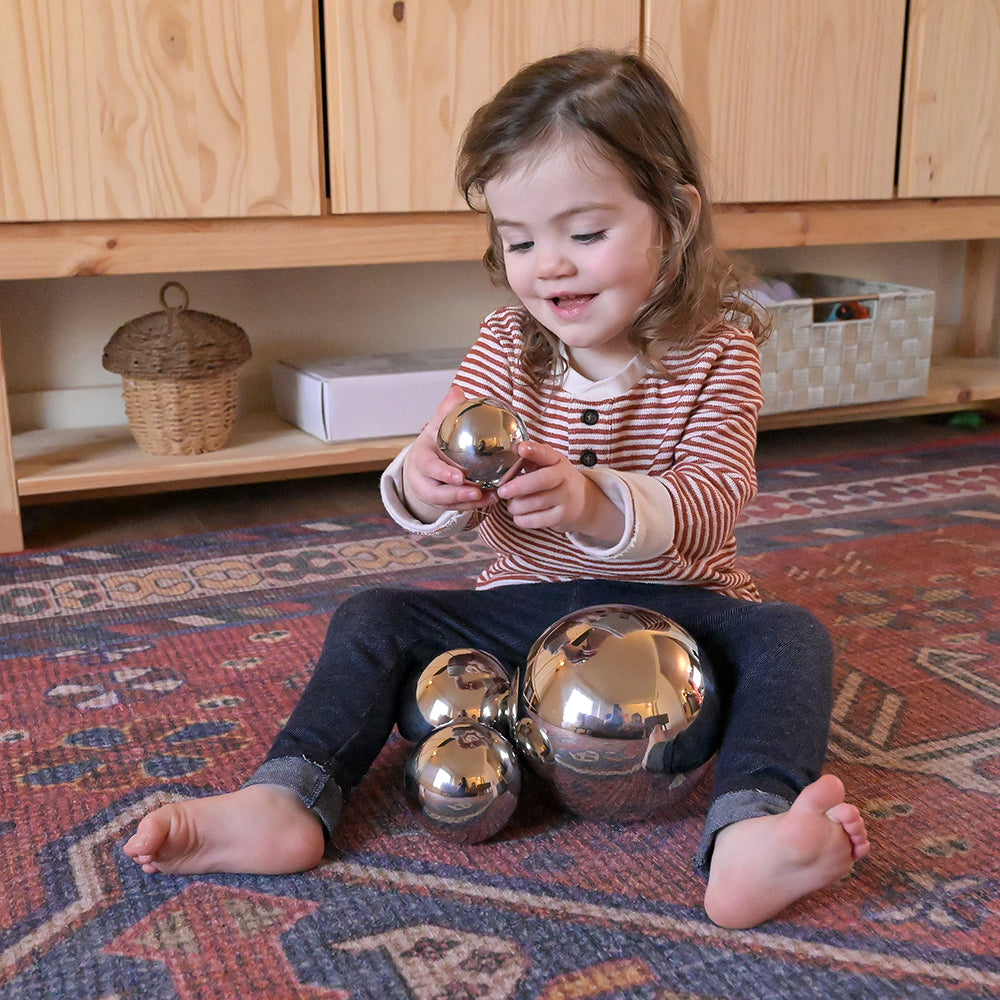 Toddler Engaging with Sensory Reflective Mirror Balls