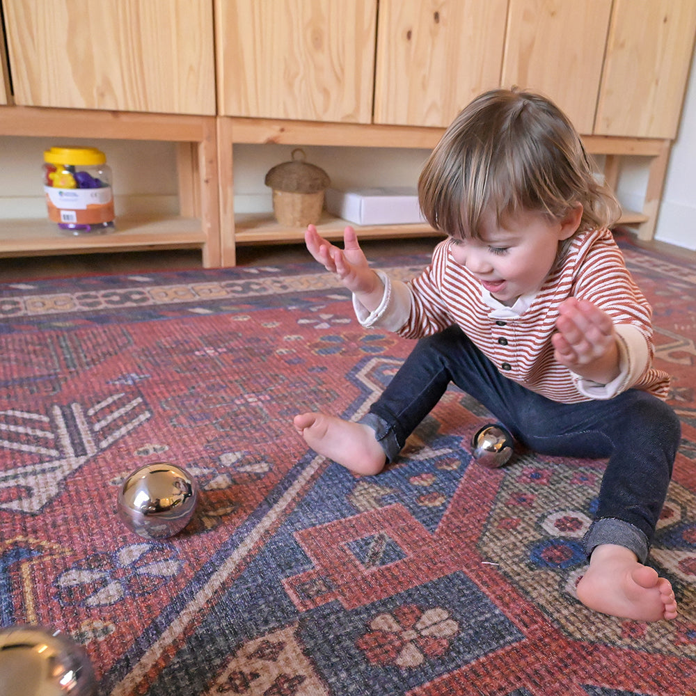 Kid Having Fun with Sensory Reflective Mirror Balls