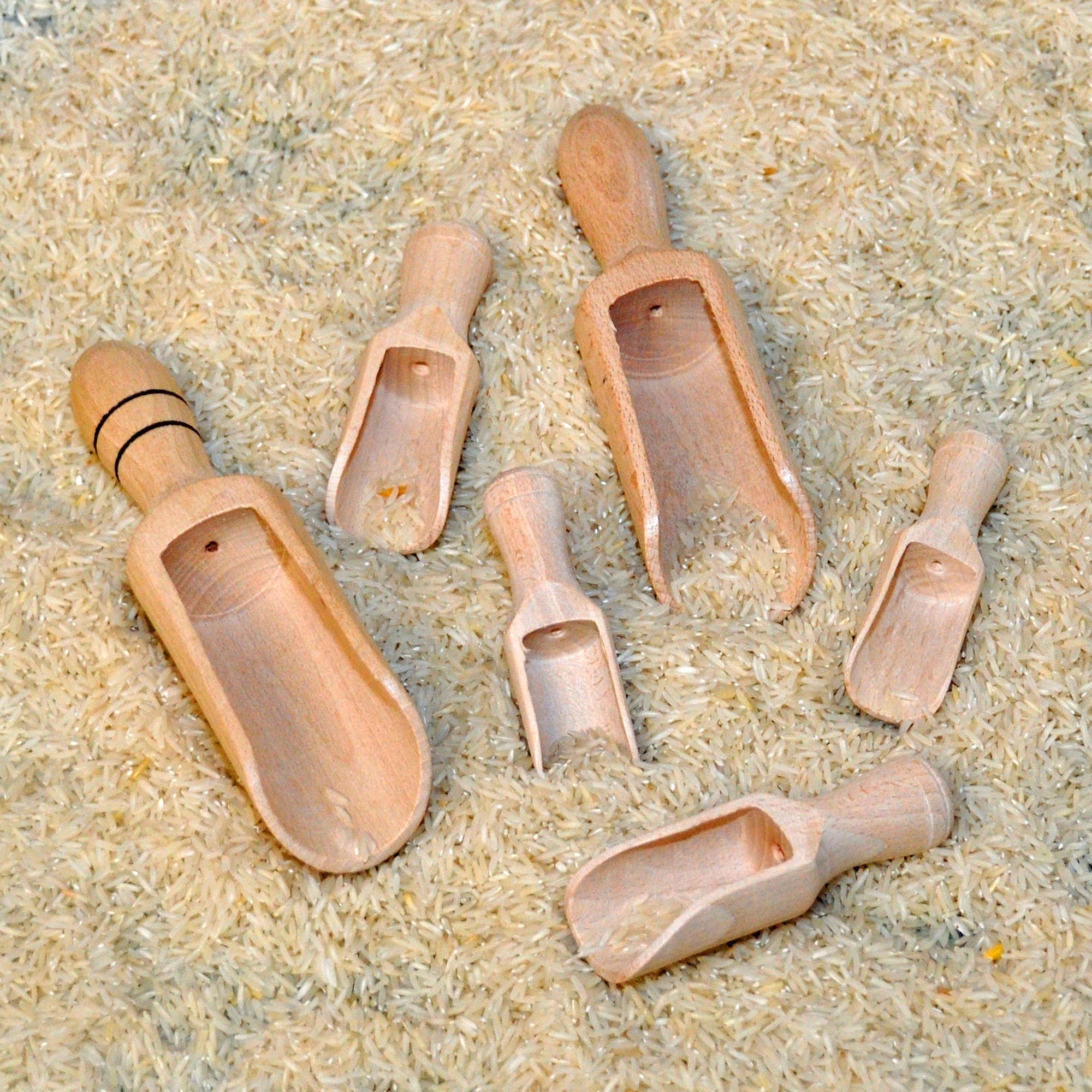 Set of wooden scoops on a textured surface