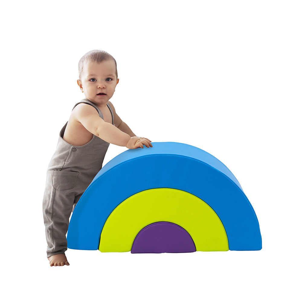 Child playing with a colorful rainbow-shaped toy on a white background
