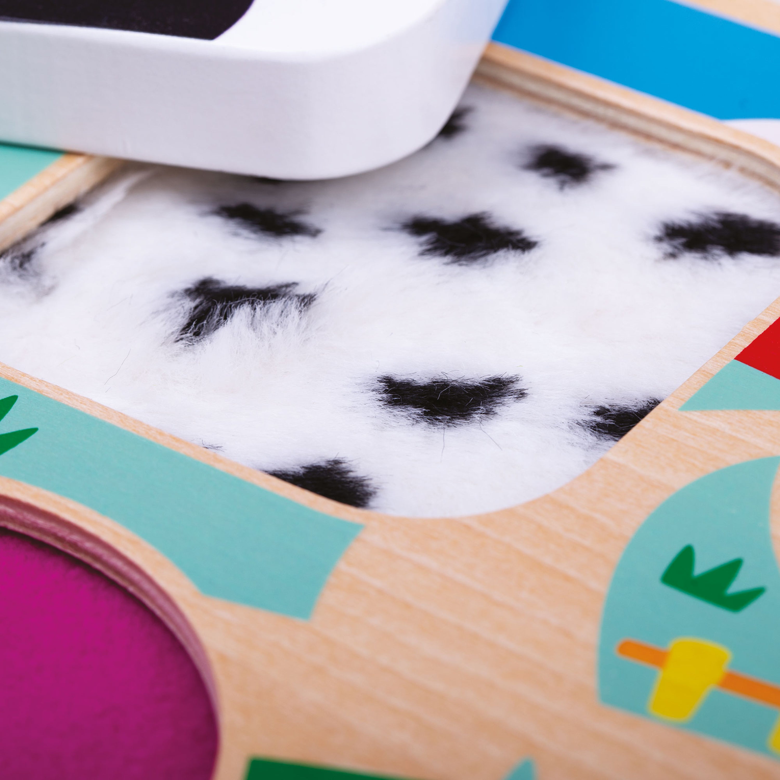 Colorful wooden toy with a white object on top