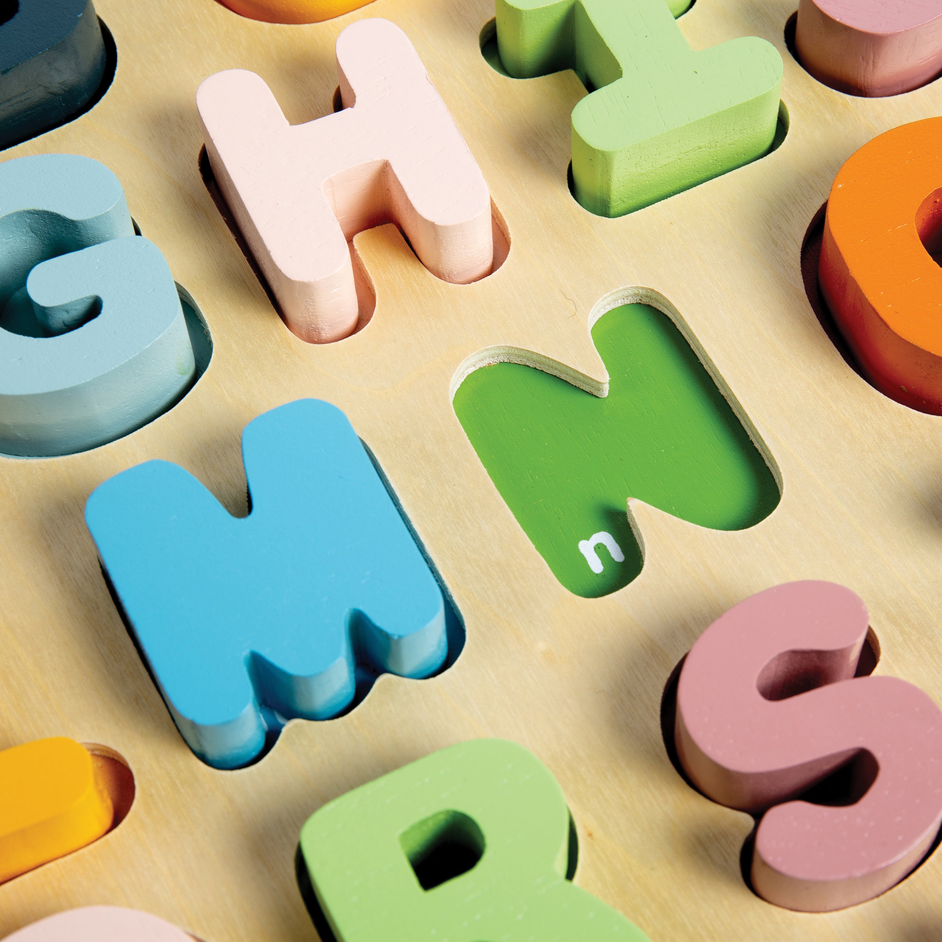 Colorful wooden letters on a wooden surface