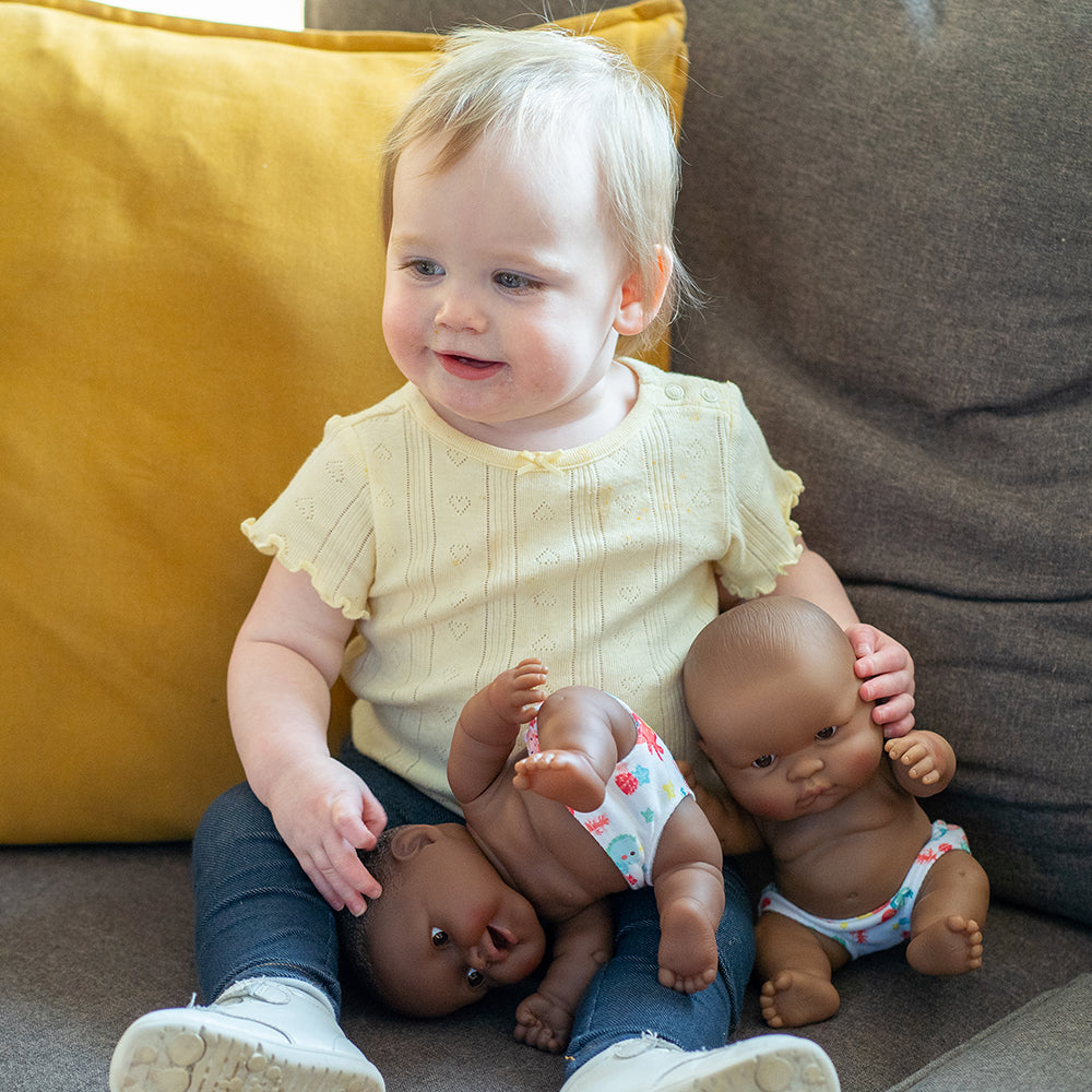 Toddler Playing with Baby Dolls