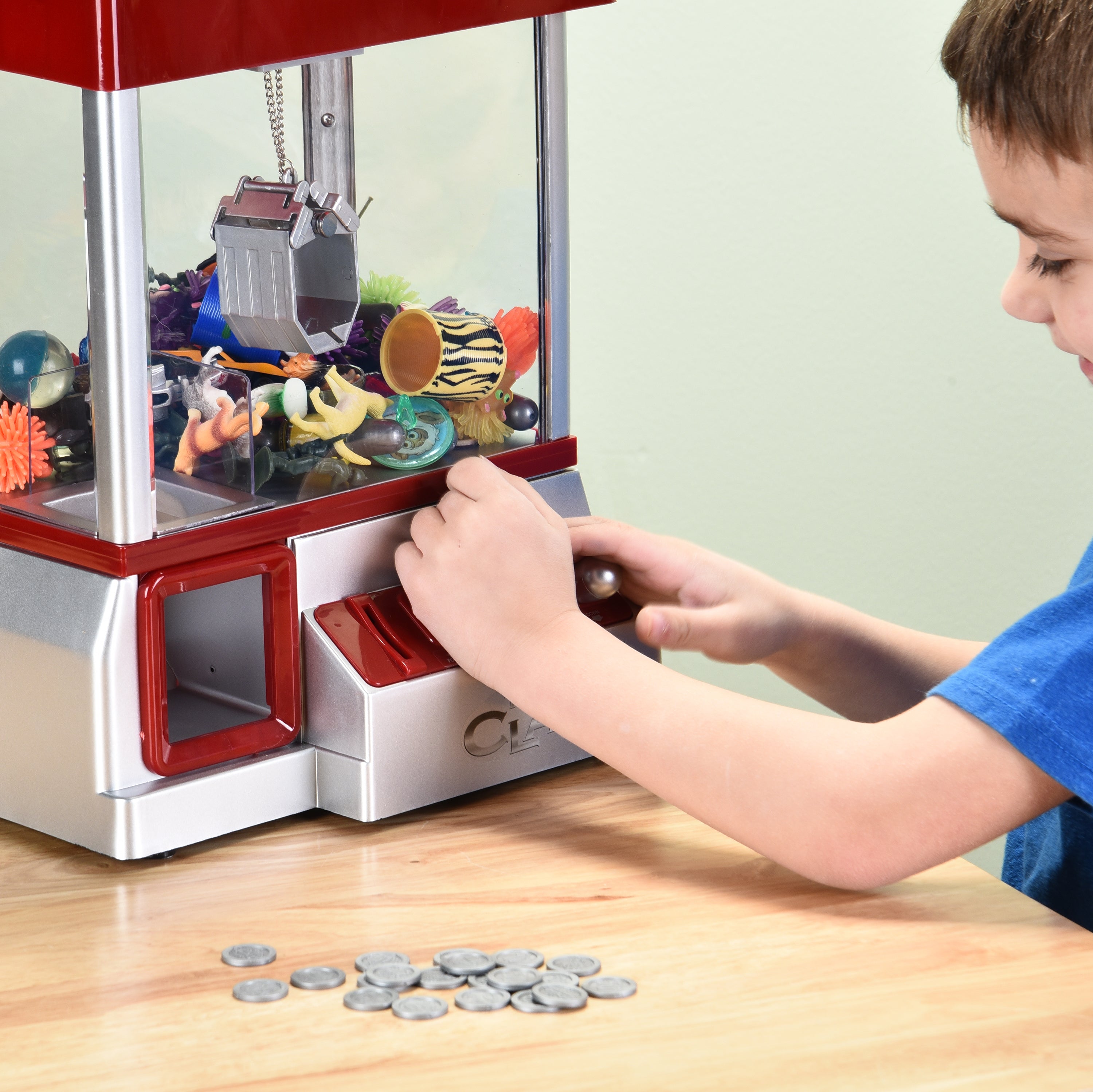 Kid Maneuvering Controls of Carnival Crane Game