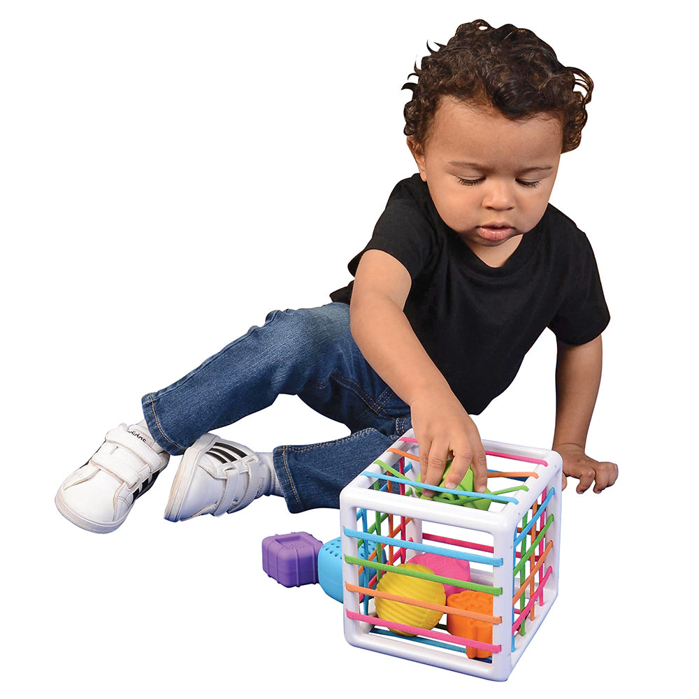 Toddler Pushing a Shape into Sensory Shape-Sorting Cube