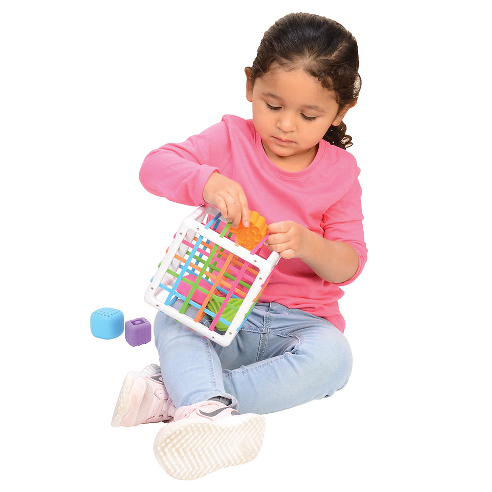 Kid Using Sensory Shape-Sorting Cube