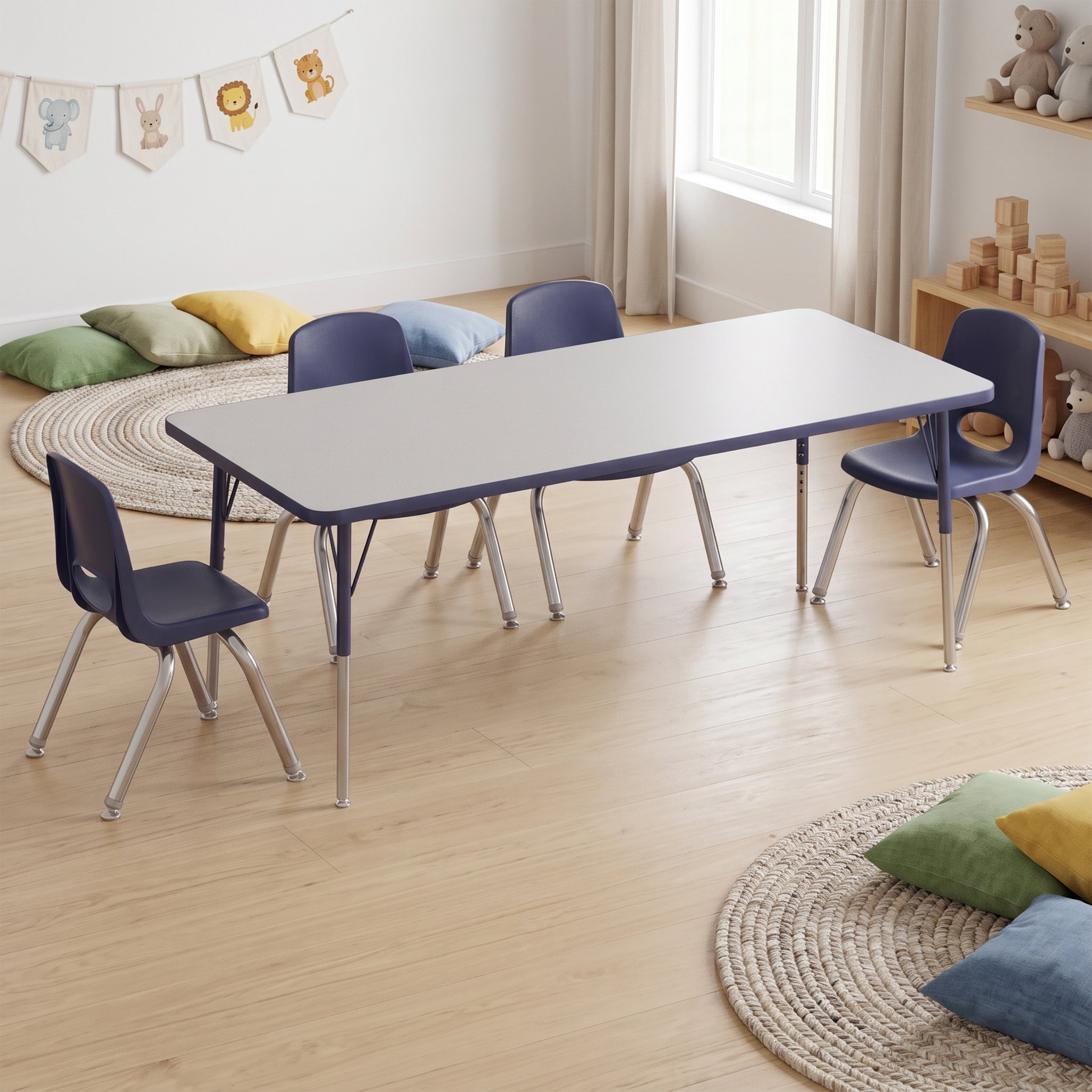 A children's table and chair set in a bright, modern playroom. The set includes a rectangular table with a light gray top and dark blue legs, surrounded by four matching chairs with dark blue seats and silver metal legs.
