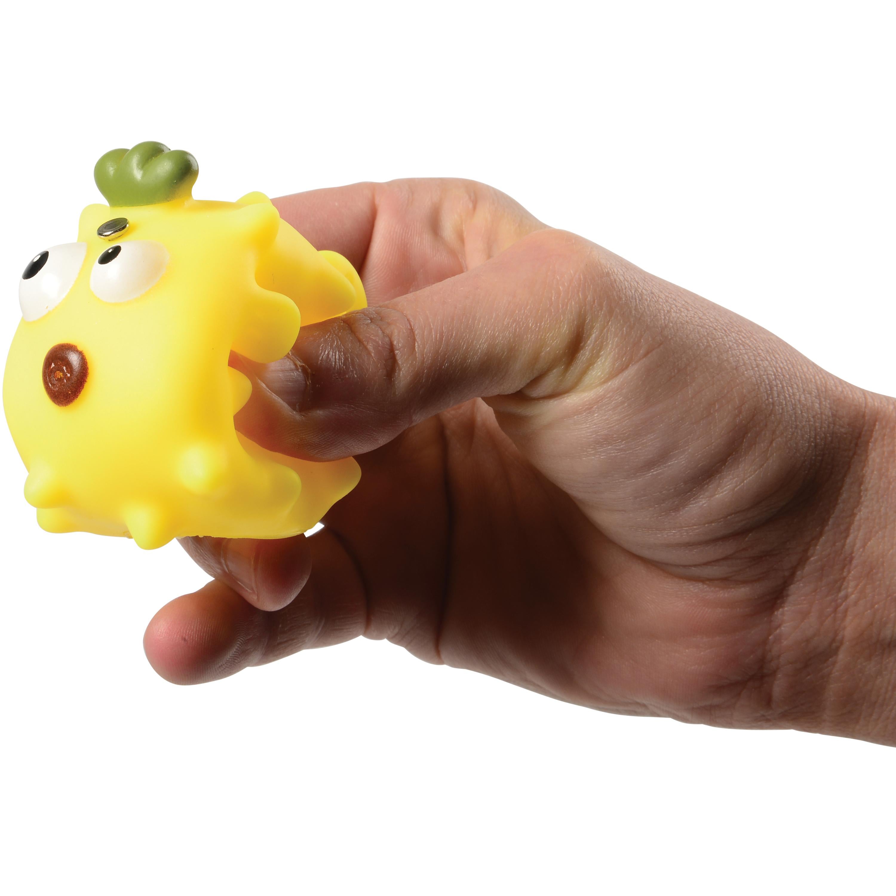 Hand holding a yellow textured object with a white background