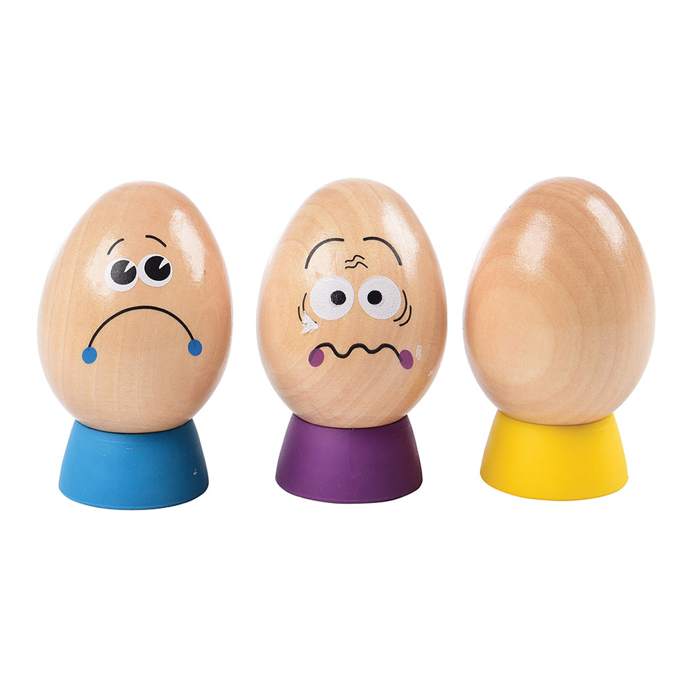 Close-up of 3 Wooden Eggs with Different Facial Expressions