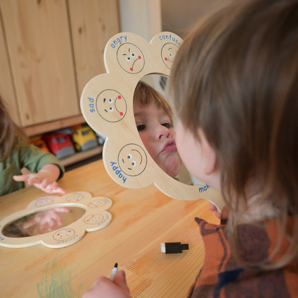 Toddler Making Faces in Mirror