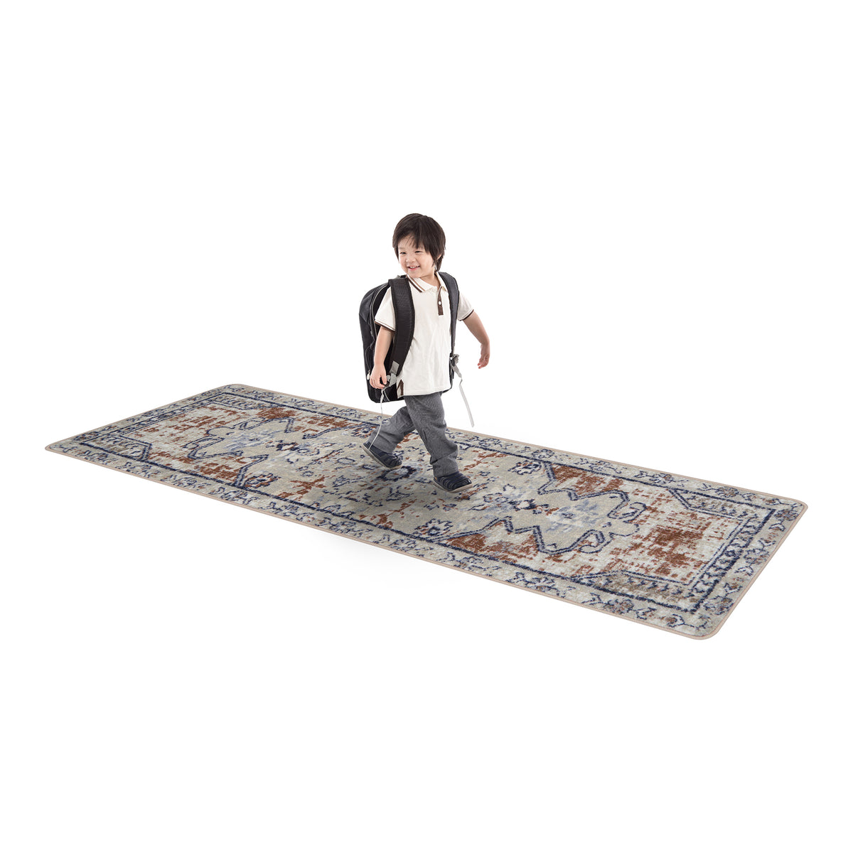 Child walking on a large patterned rug with a white background