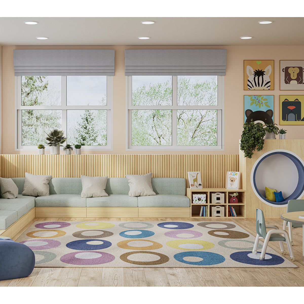 A colorful children's play rug with large concentric circle patterns in multiple colors, shown in a modern, well-lit children's playroom with a light wood floor, built-in sofa, and play equipment.