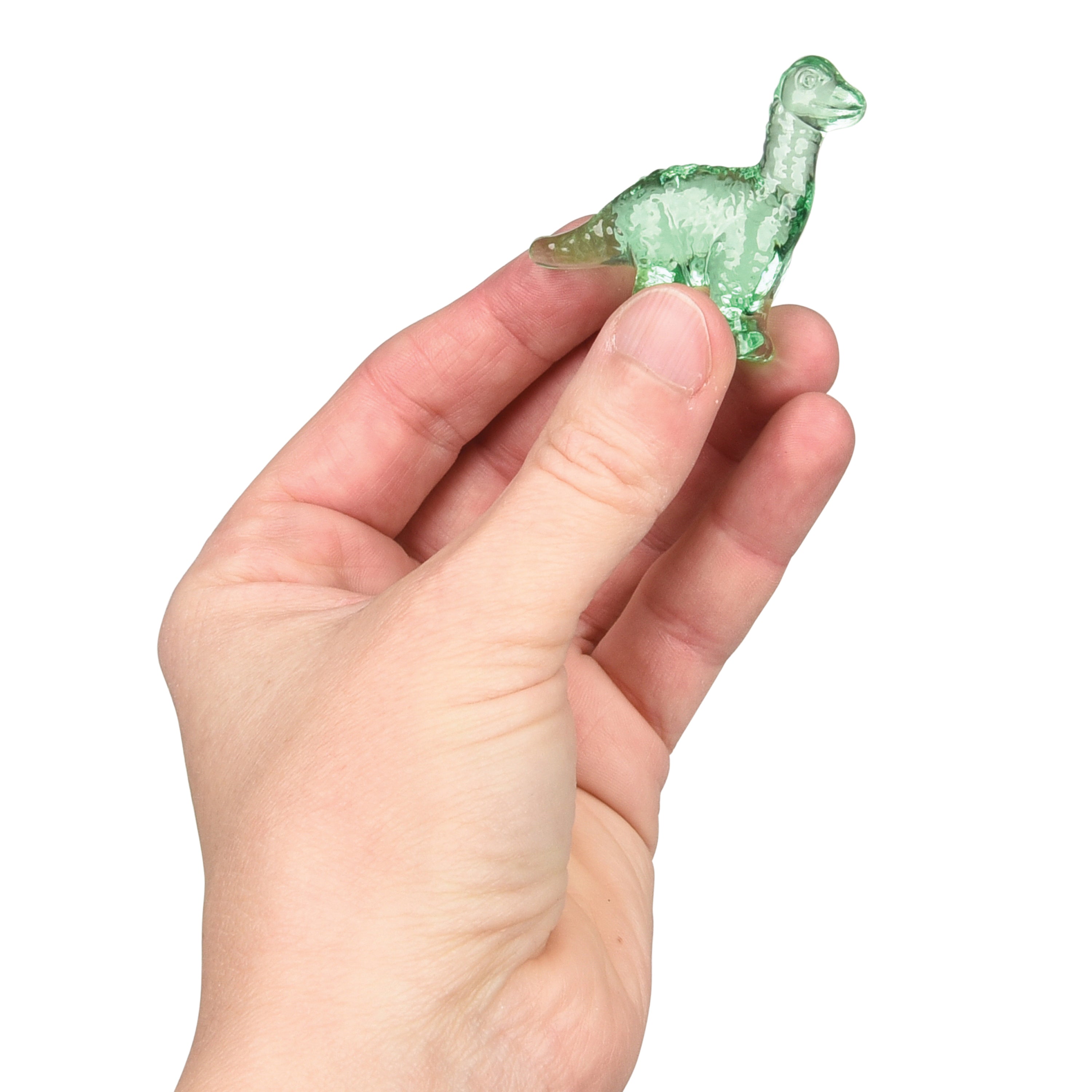 Hand holding a small green dinosaur figurine against a white background