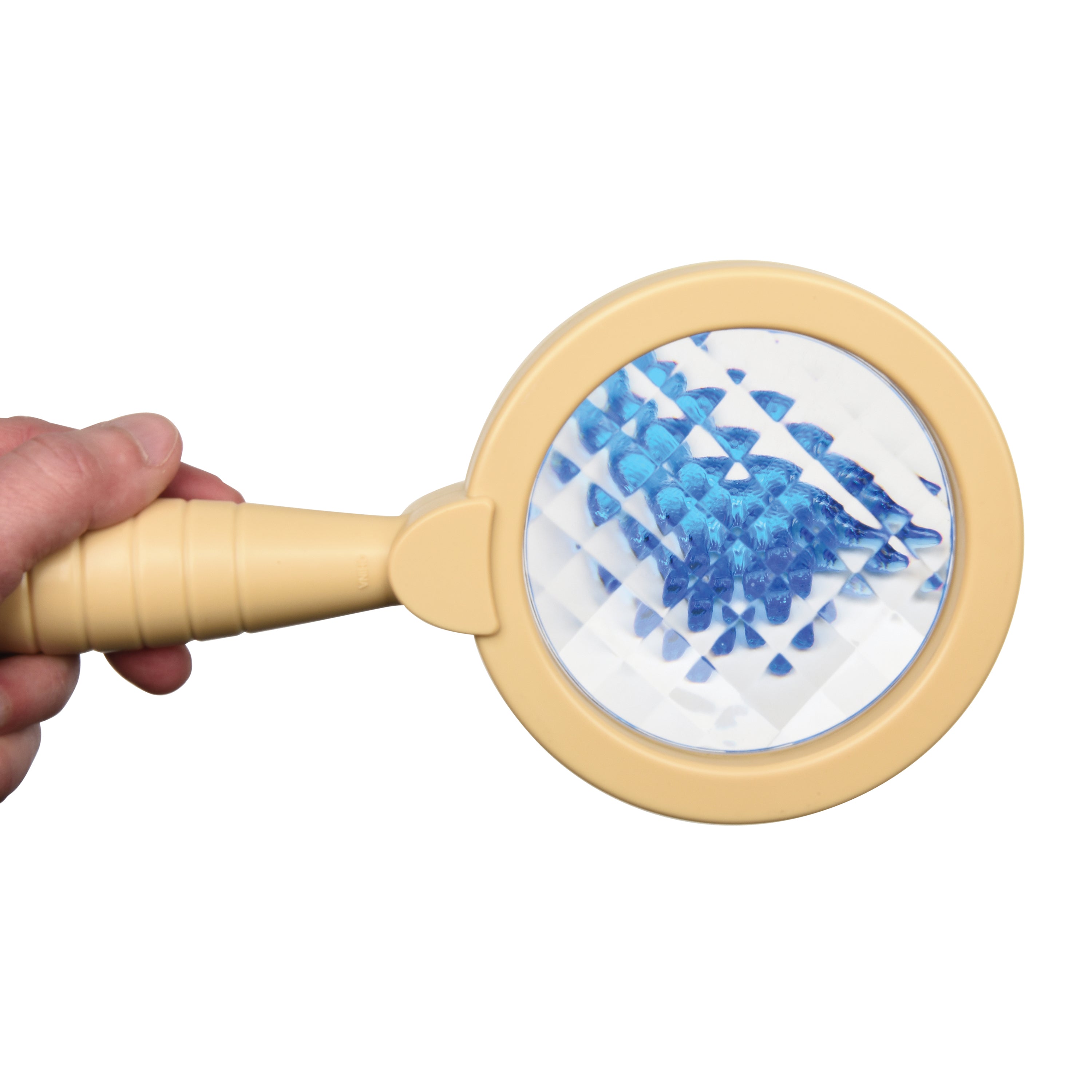 Hand holding a beige handheld magnifier with blue and white patterned filter on a white background
