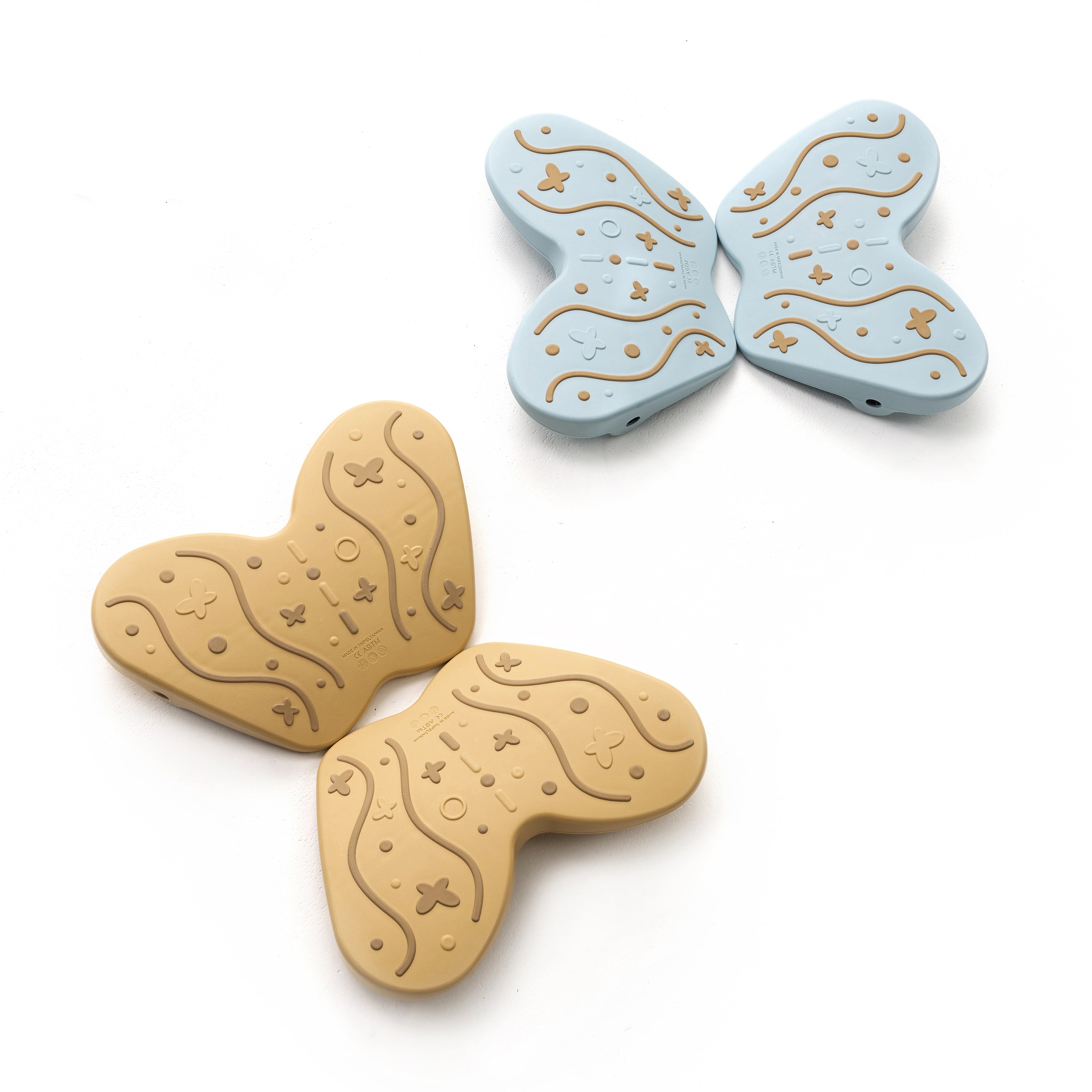 Two butterfly-shaped items, one beige and one blue, on a white background