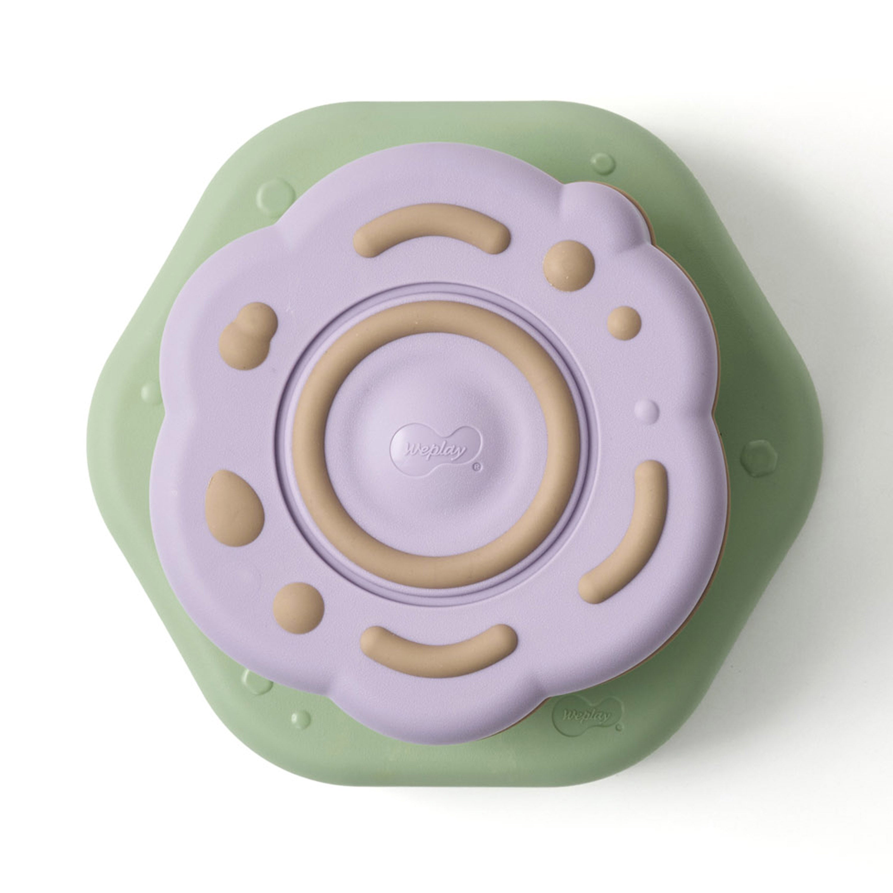 Children's toy with a purple top and green base on a white background