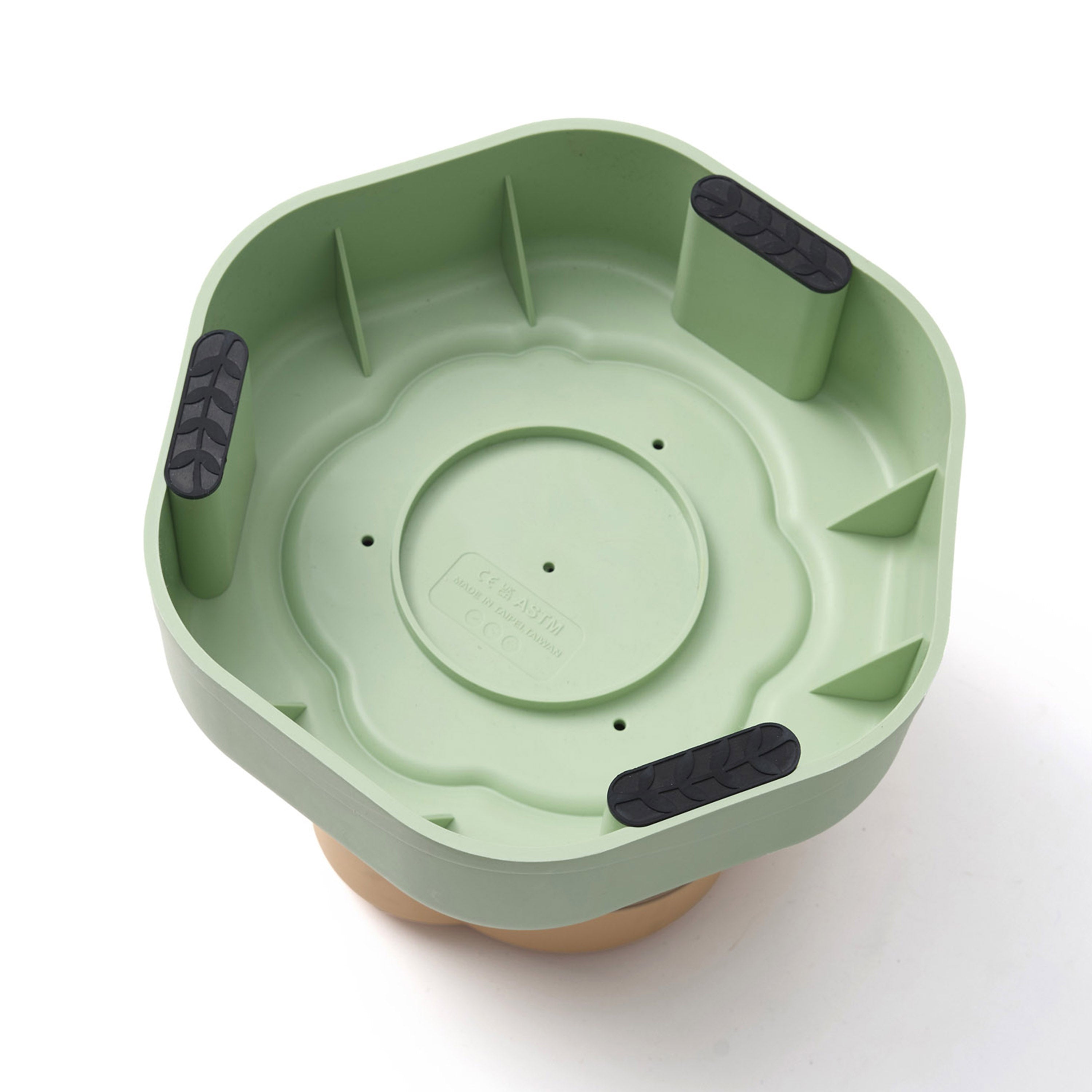 Green plastic product with black accents on a white background