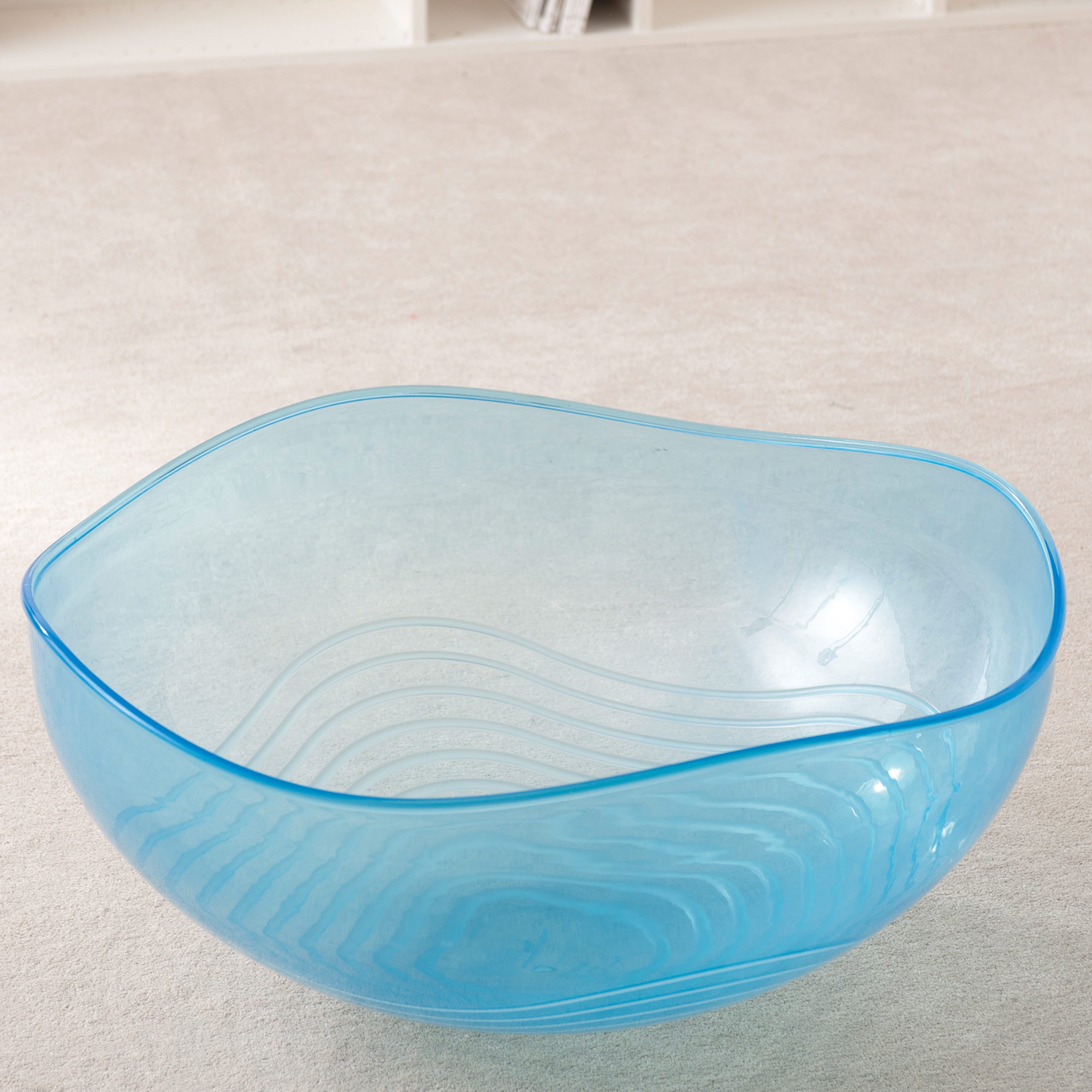 Blue plastic bowl on a light gray surface