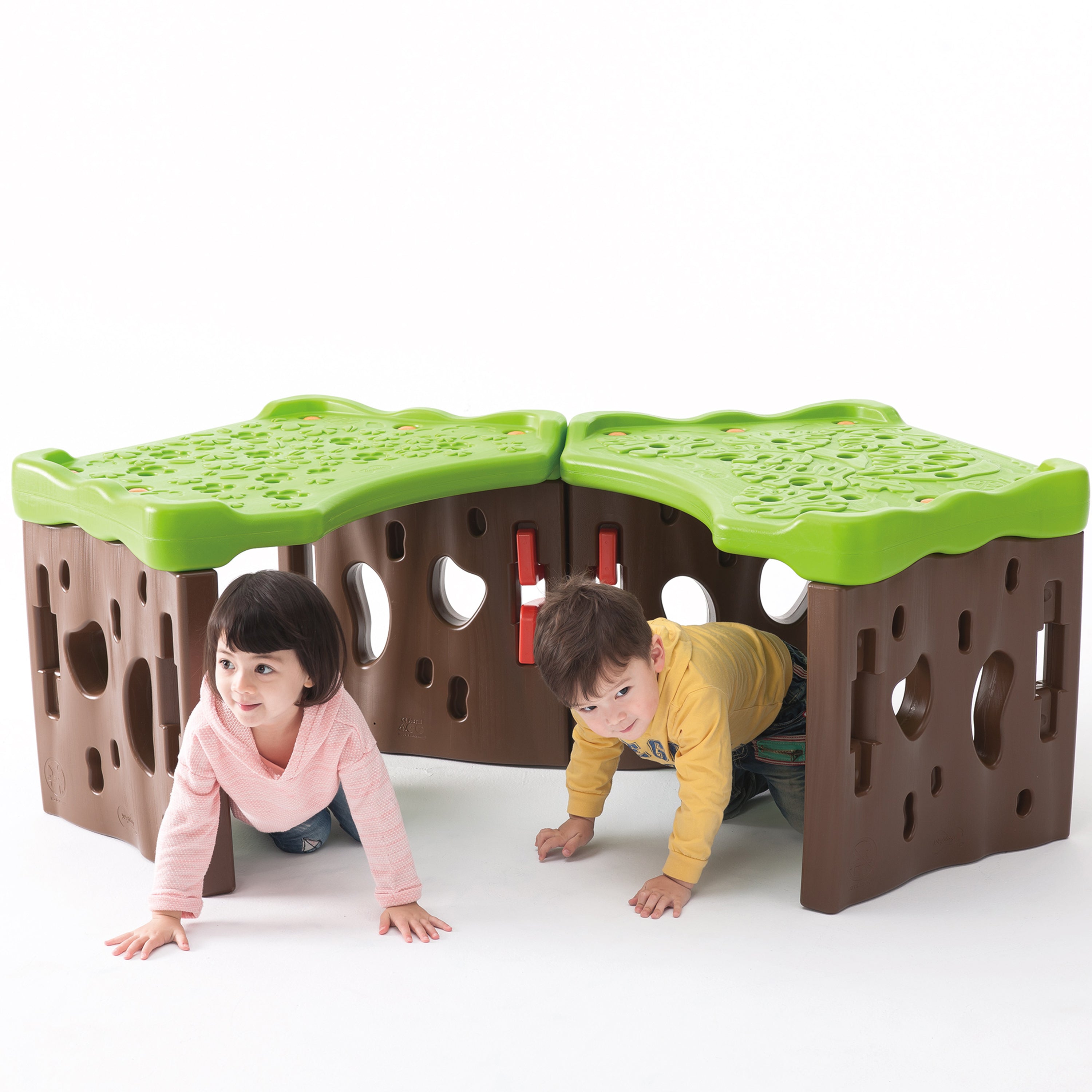 Children playing with a green and brown play structure on a white background