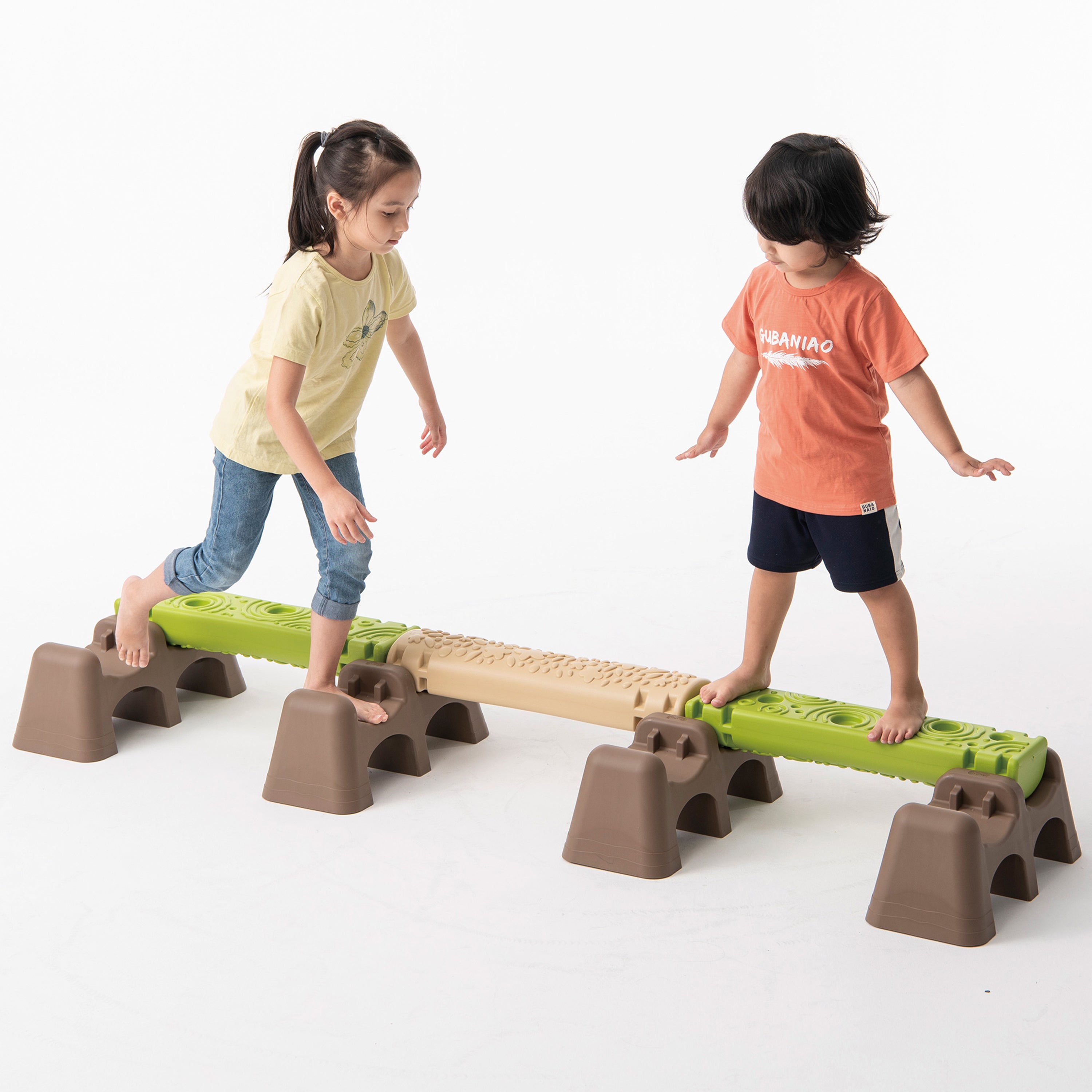 Two children playing on a set of playground equipment with green and brown platforms.