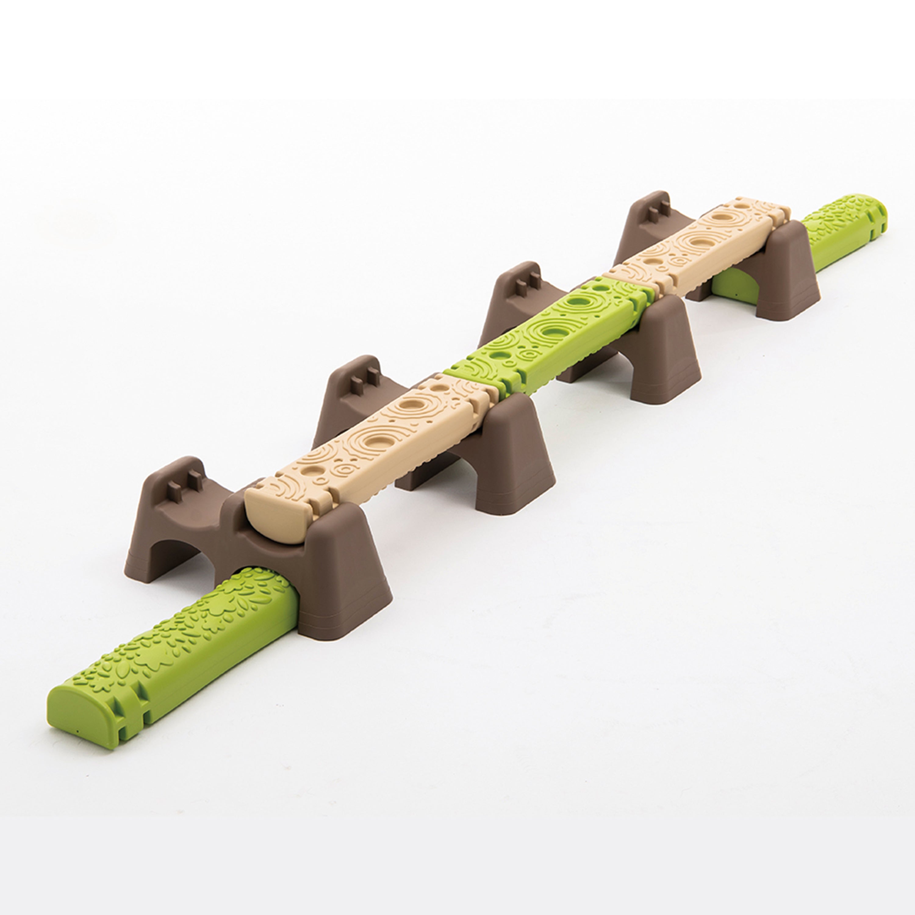 Children's balance beam with brown supports and green and beige steps on a white background