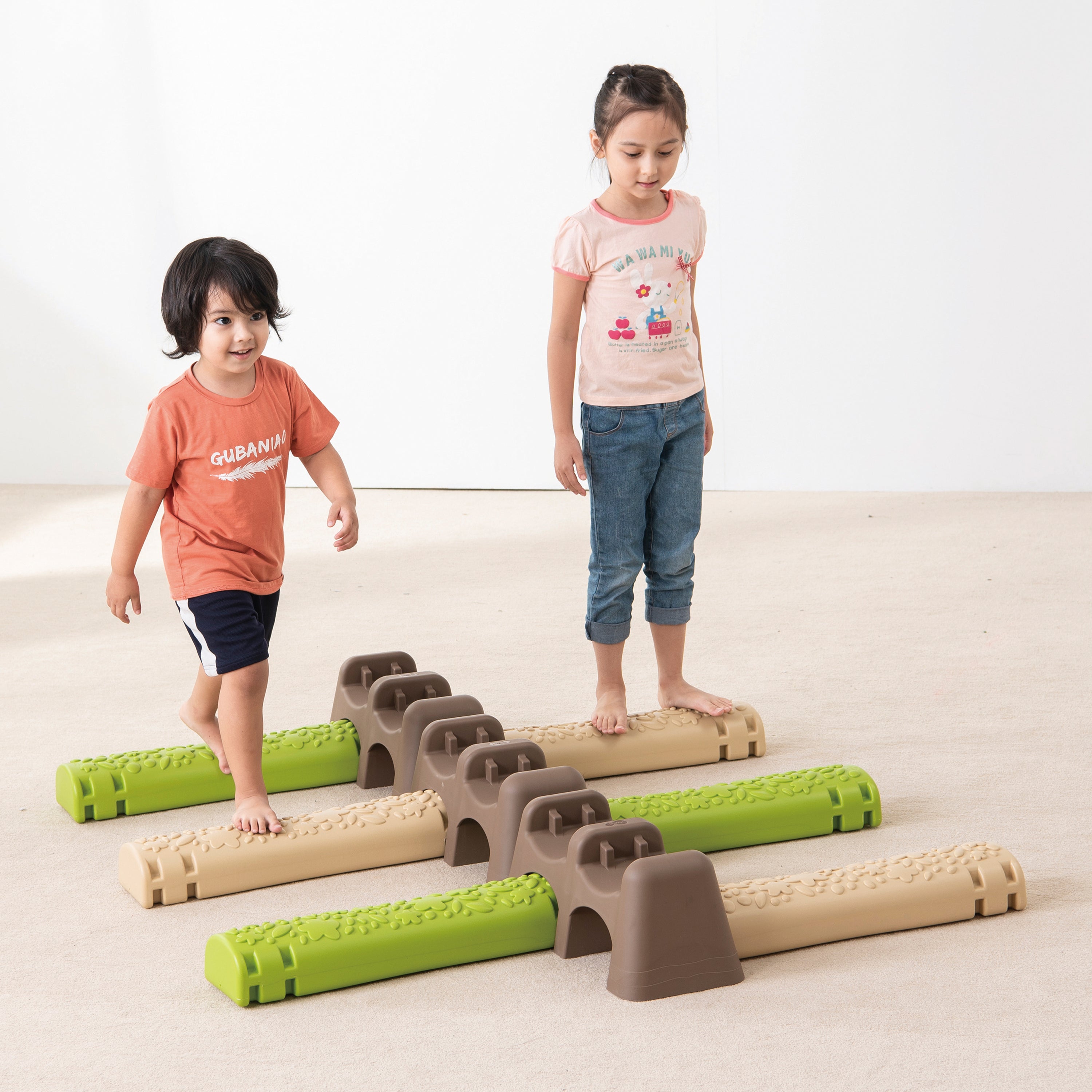 Two children playing with a set of interlocking blocks on a light background