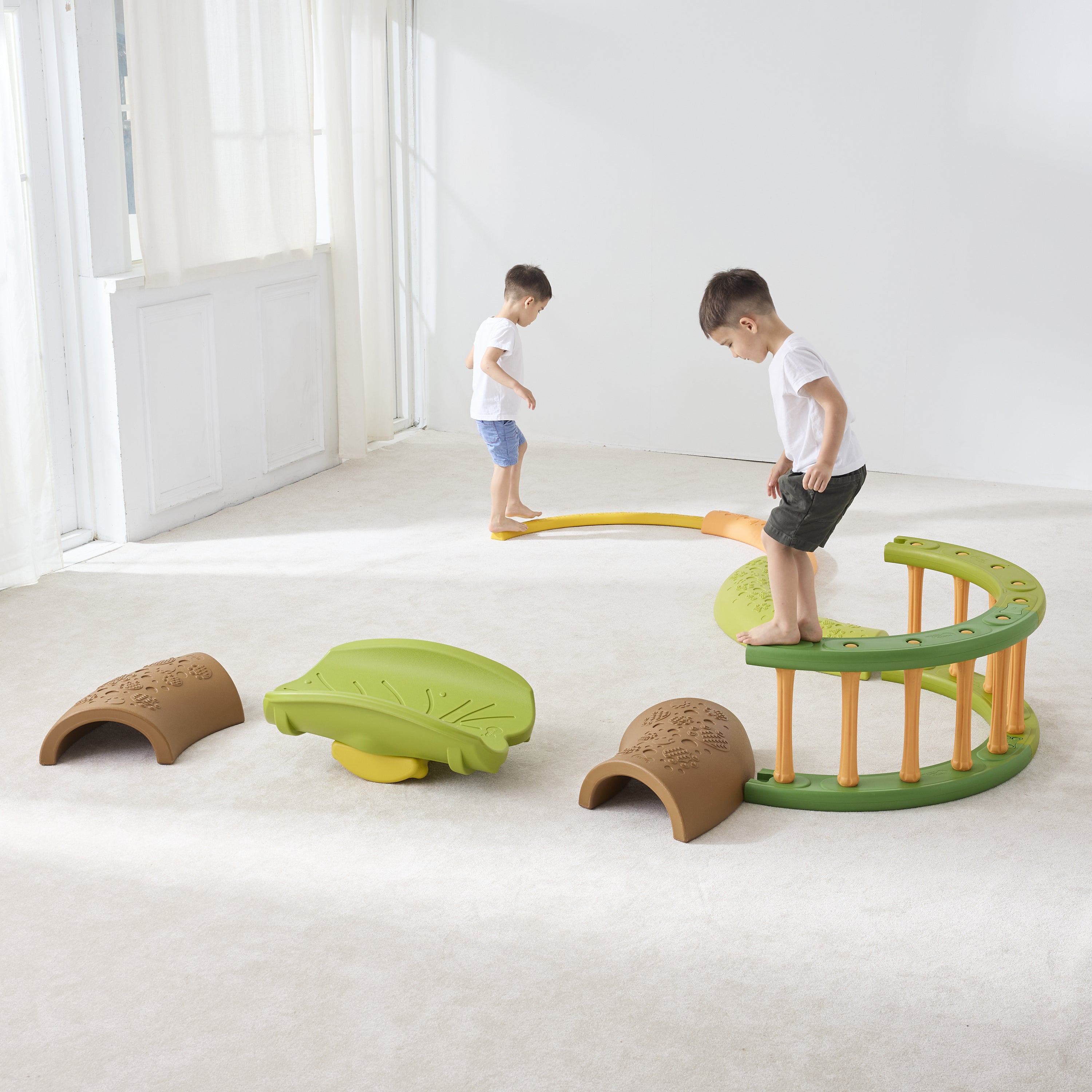 Children playing with a colorful playground set indoors.