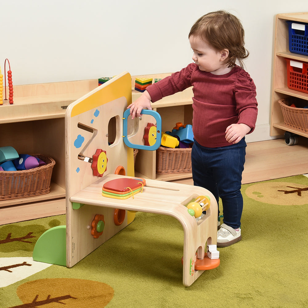 Toddler Interacting with Early Exploration Panel in the classroom