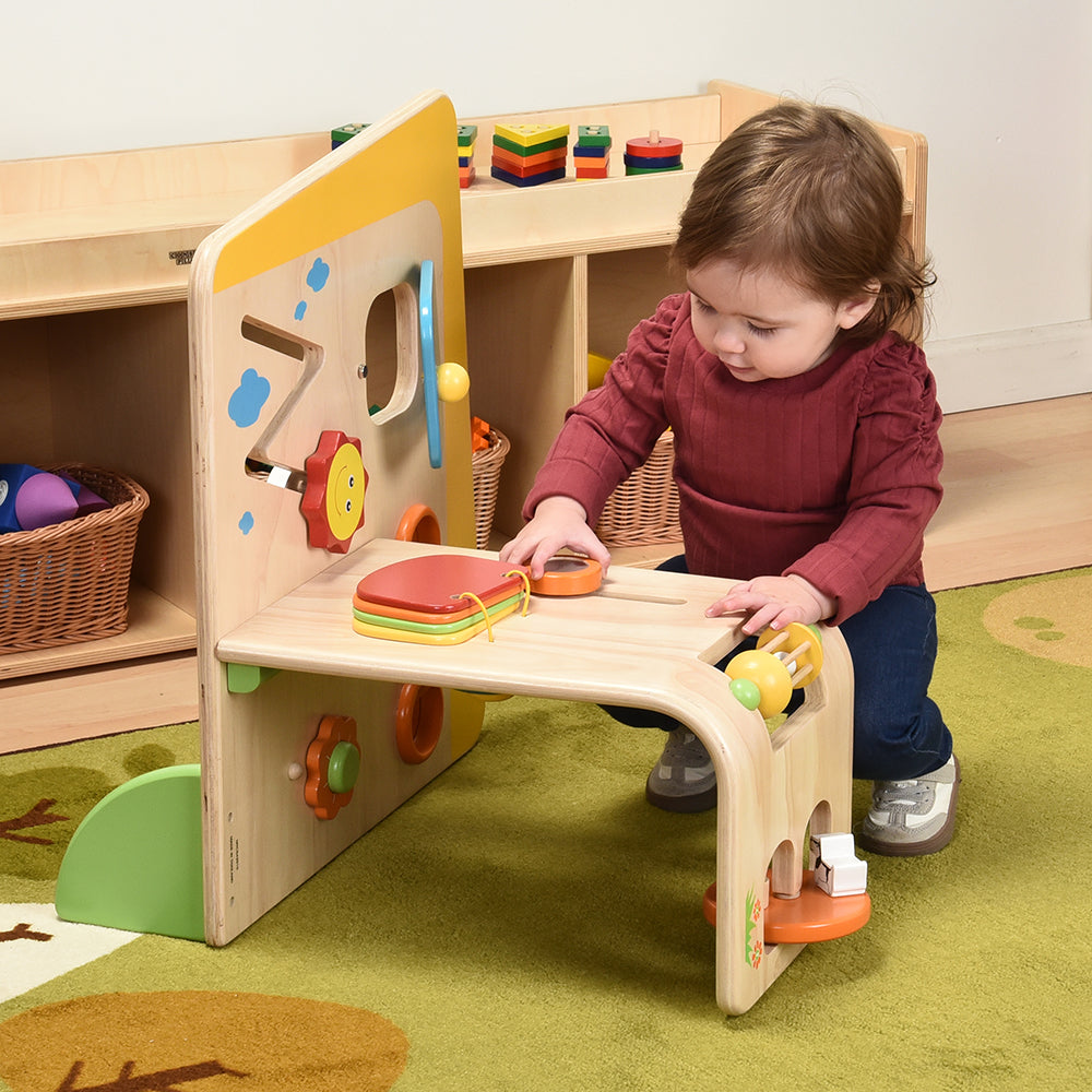 Toddler Playing with Early Exploration Panel in the classroom