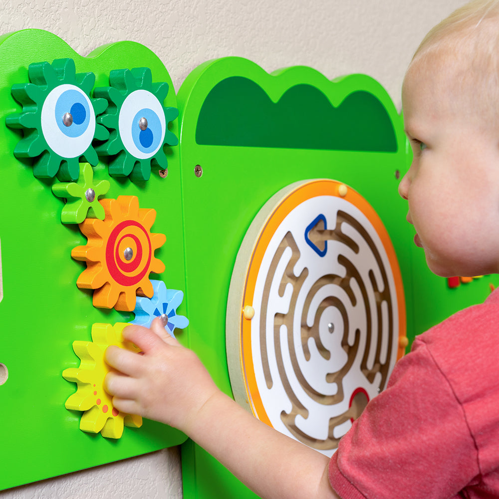 Toddler Working with Gears on Wall Panel