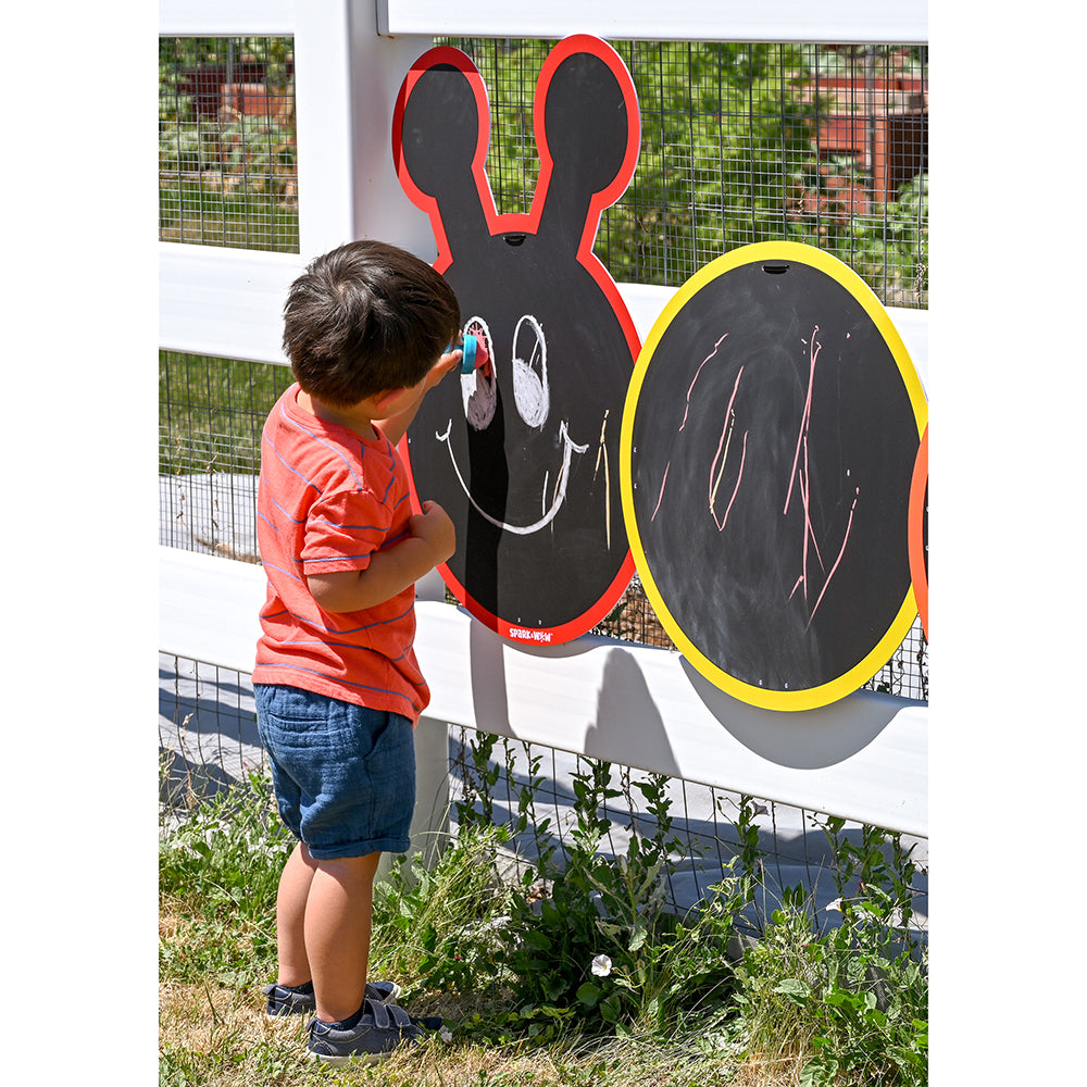 Kid Drawing A Face On Caterpillar Shaped Chalkboard