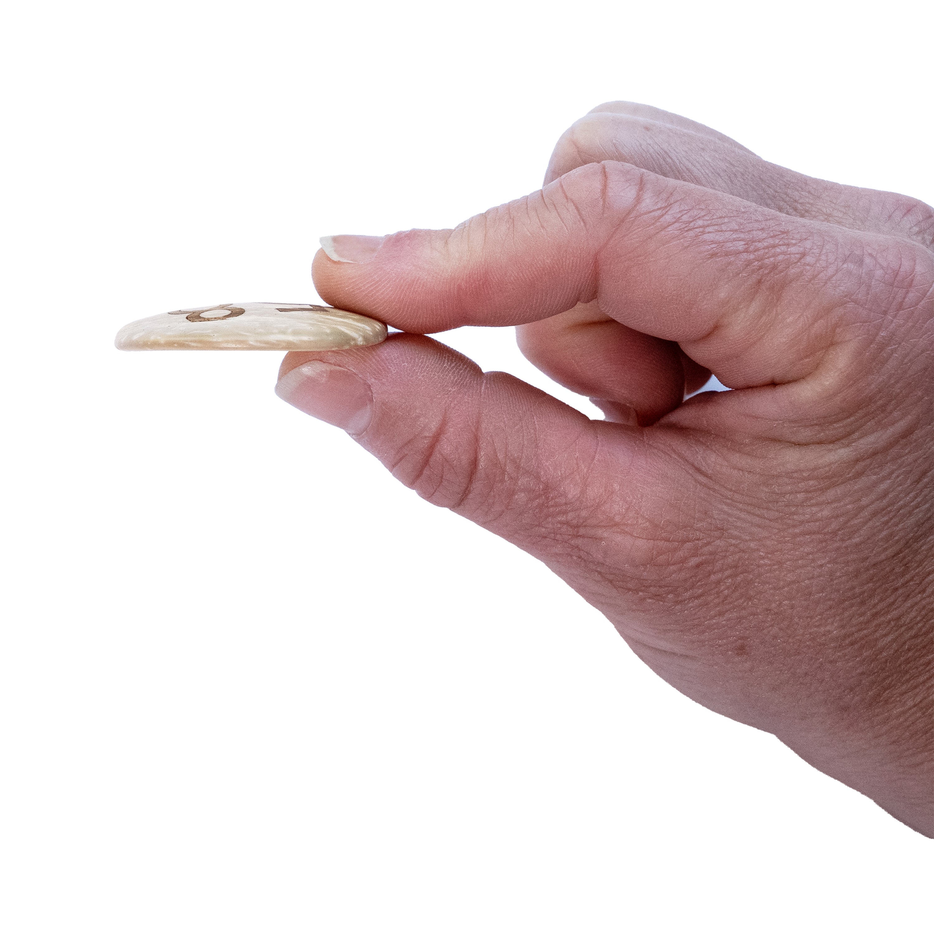 One natural colored button pinched between two fingers on a white background