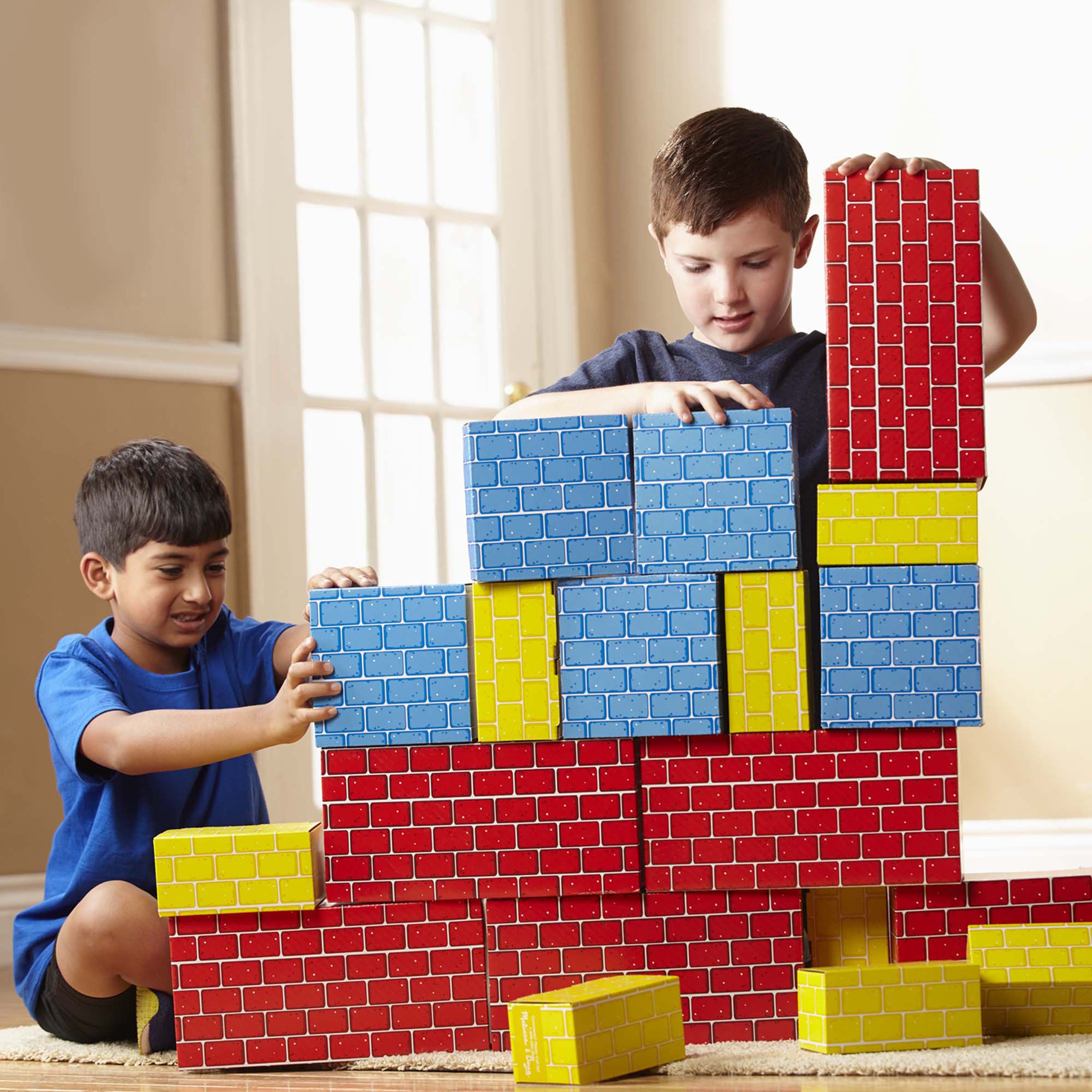 Two children playing with colorful building blocks indoors.